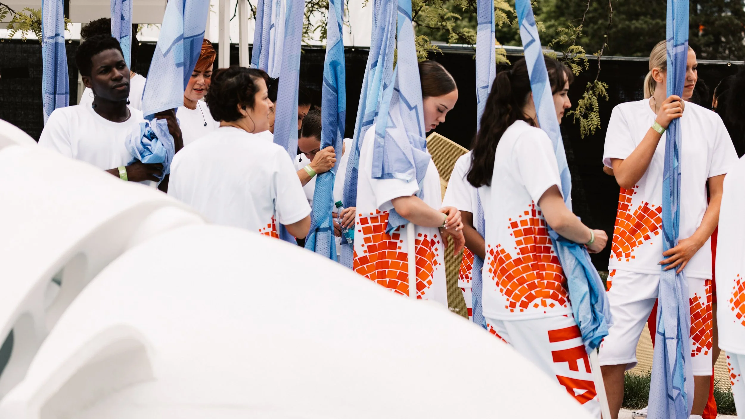 Performers carrying golden globe panels and blue ocean flags backstage before the FIFA World Cup 2026 Toronto Opening Ceremony.