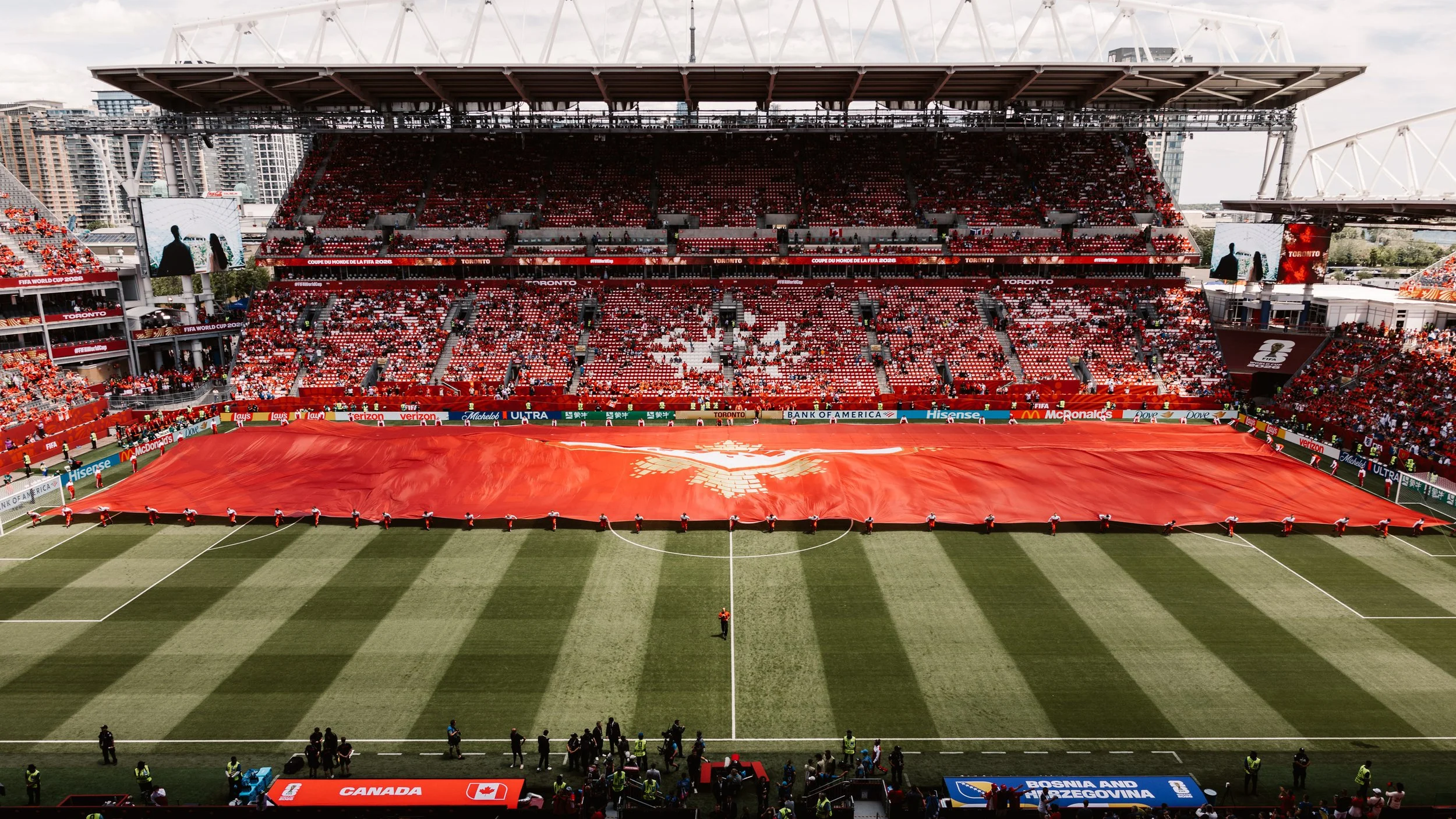Large red maple leaf field cloth covering the stadium during the FIFA World Cup 2026 Toronto Opening Ceremony, designed by Production Designer Ruby Law.