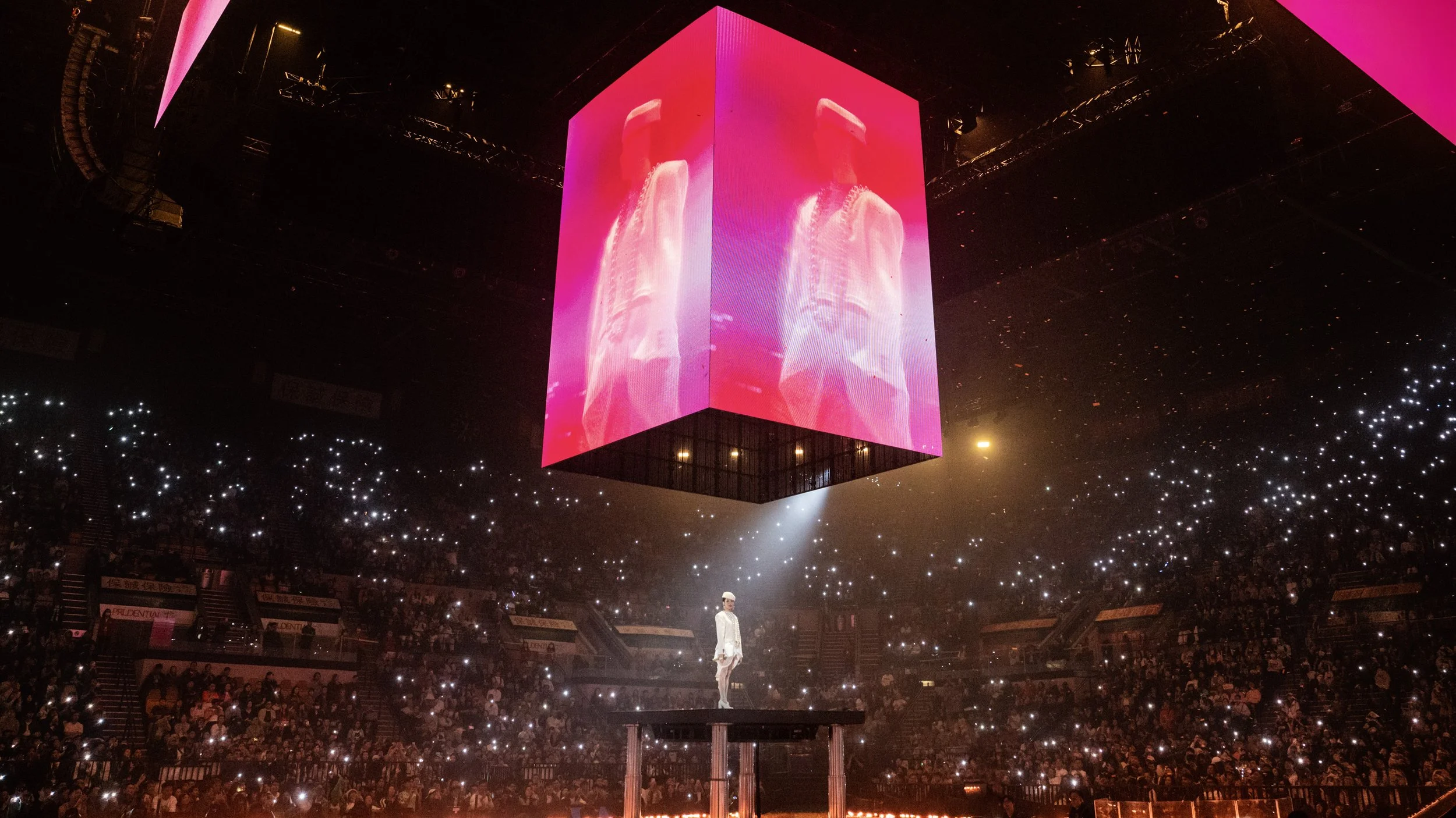 Suspended LED cube above central arena platform with Jace Chan performing beneath in Jace World, large scale concert stage design by London set designer Ruby Law.