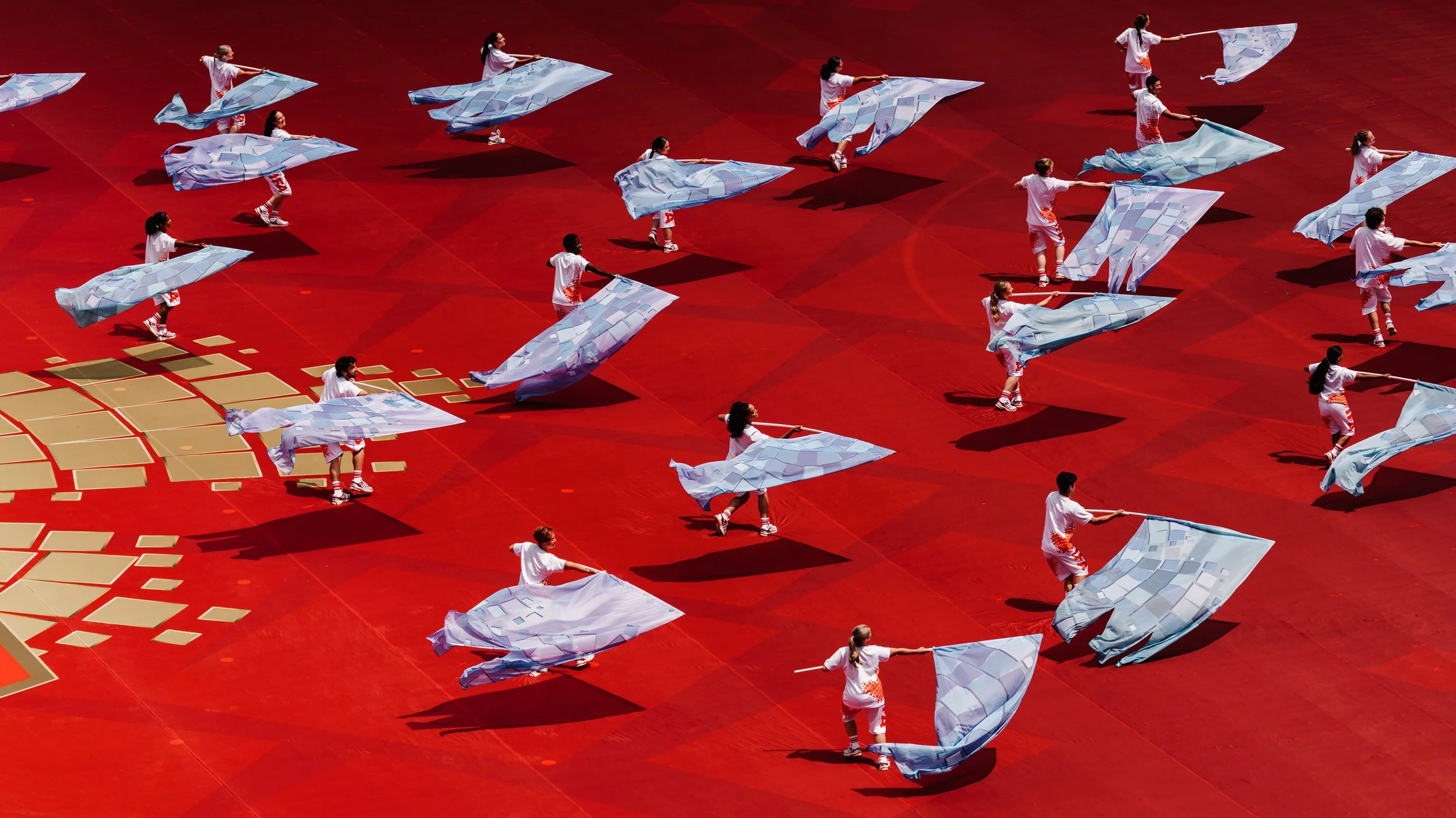 Performers waving blue fabric flags representing Canada's oceans during the FIFA World Cup 2026 Toronto Opening Ceremony, designed by Ruby Law [RULA]
