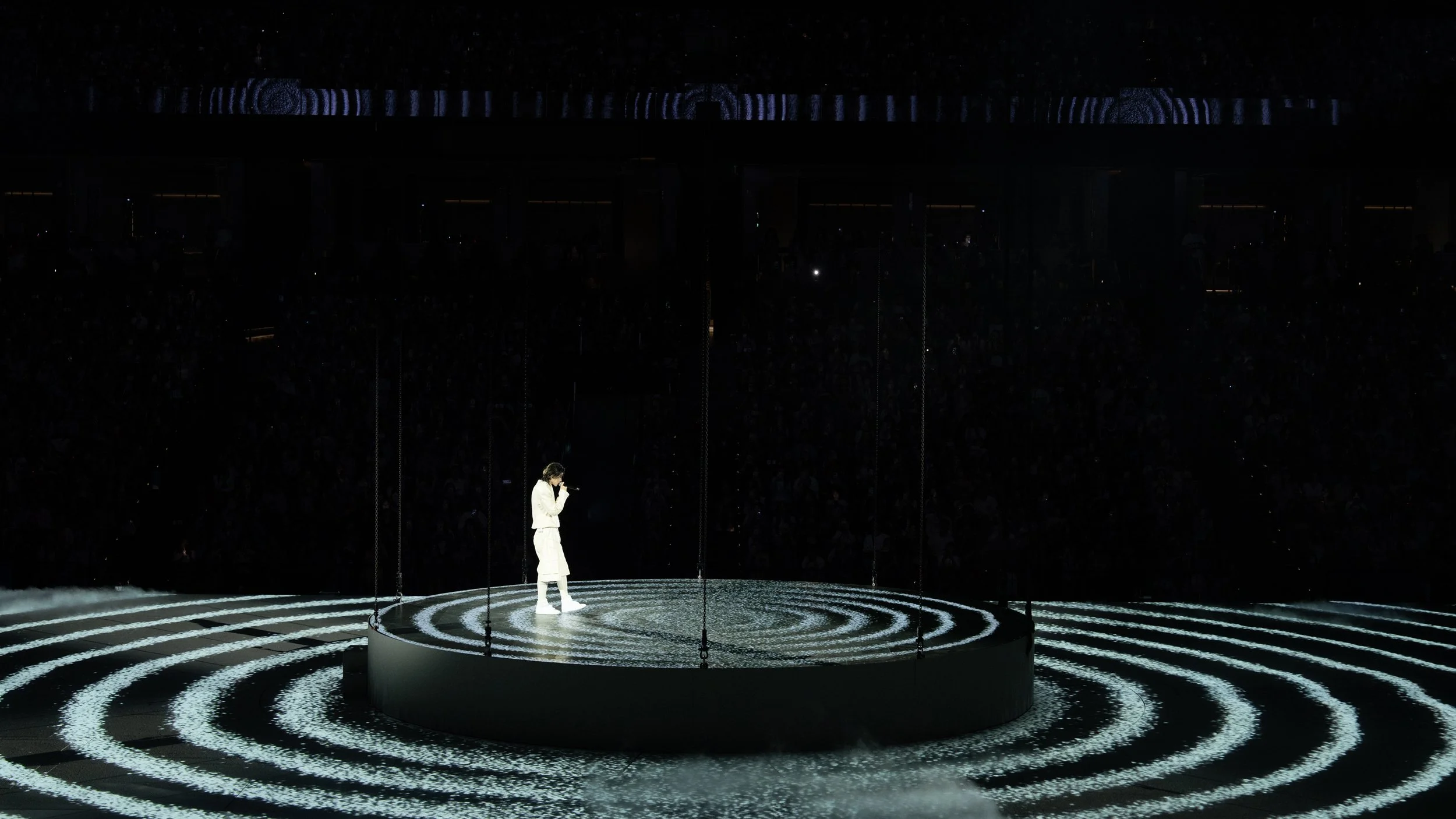 KUN 蔡徐坤 standing on a suspended circular platform surrounded by concentric projections, stage design by set designer Ruby Law, RULA 舞美設計.