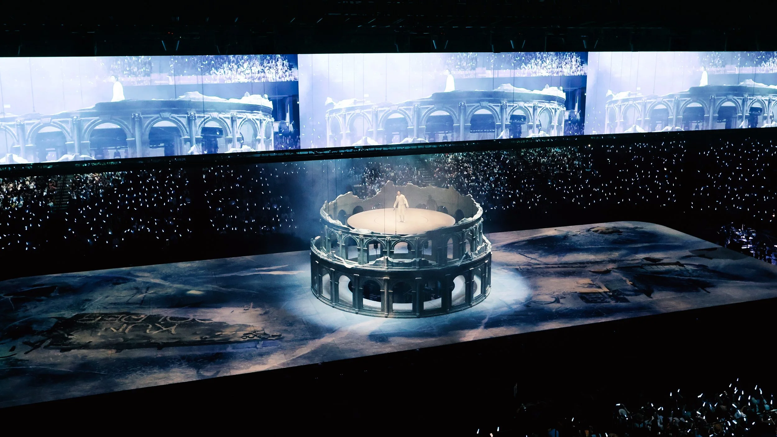 KUN 蔡徐坤 performing above a monumental ruined colosseum for Deadman, concert set and stage design by Ruby Law, RULA 舞美設計師.