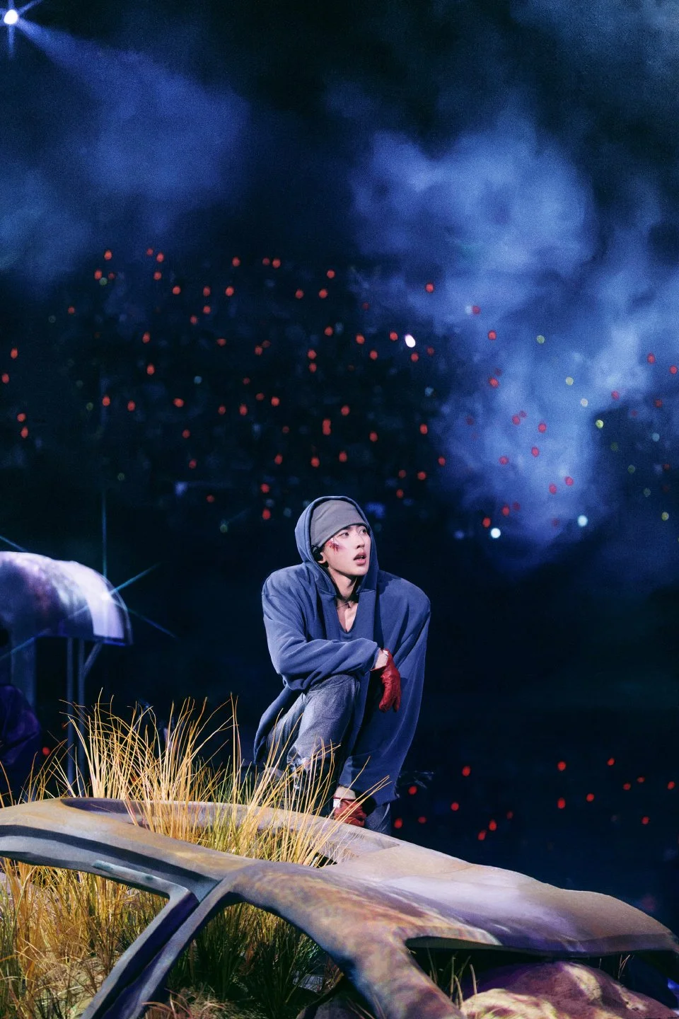 Portrait of KUN 蔡徐坤 within the abandoned car landscape of DEADMAN, concert stage design by Ruby Law