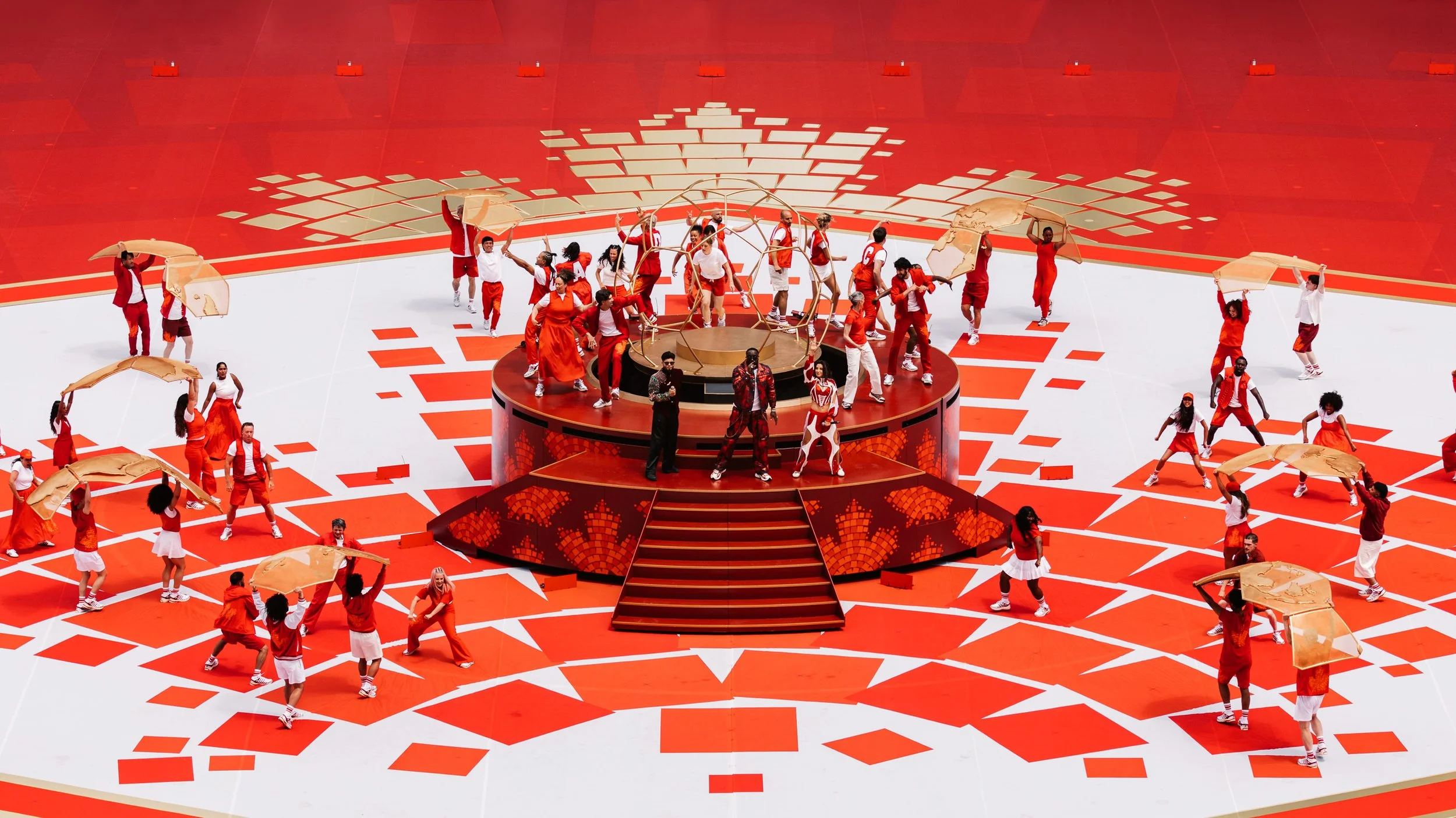 Performers assembling the golden globe structure on stage during the FIFA World Cup 2026 Toronto Opening Ceremony designed by Ruby Law.