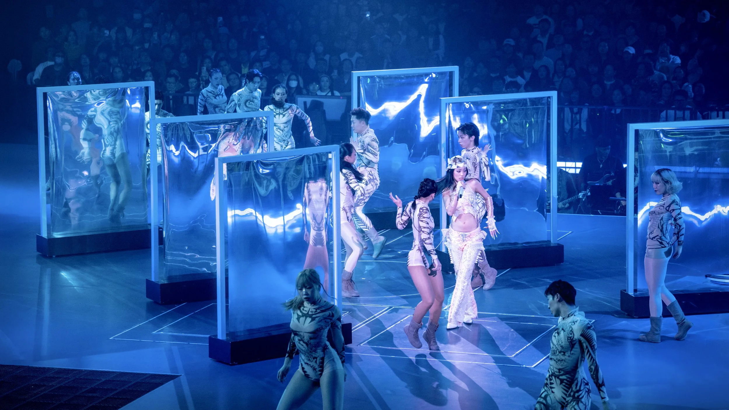 Jace Chan performing within geometric light portals inspired by the Green Snake mythology concept in Jace World, pop concert stage design by London set designer Ruby Law.