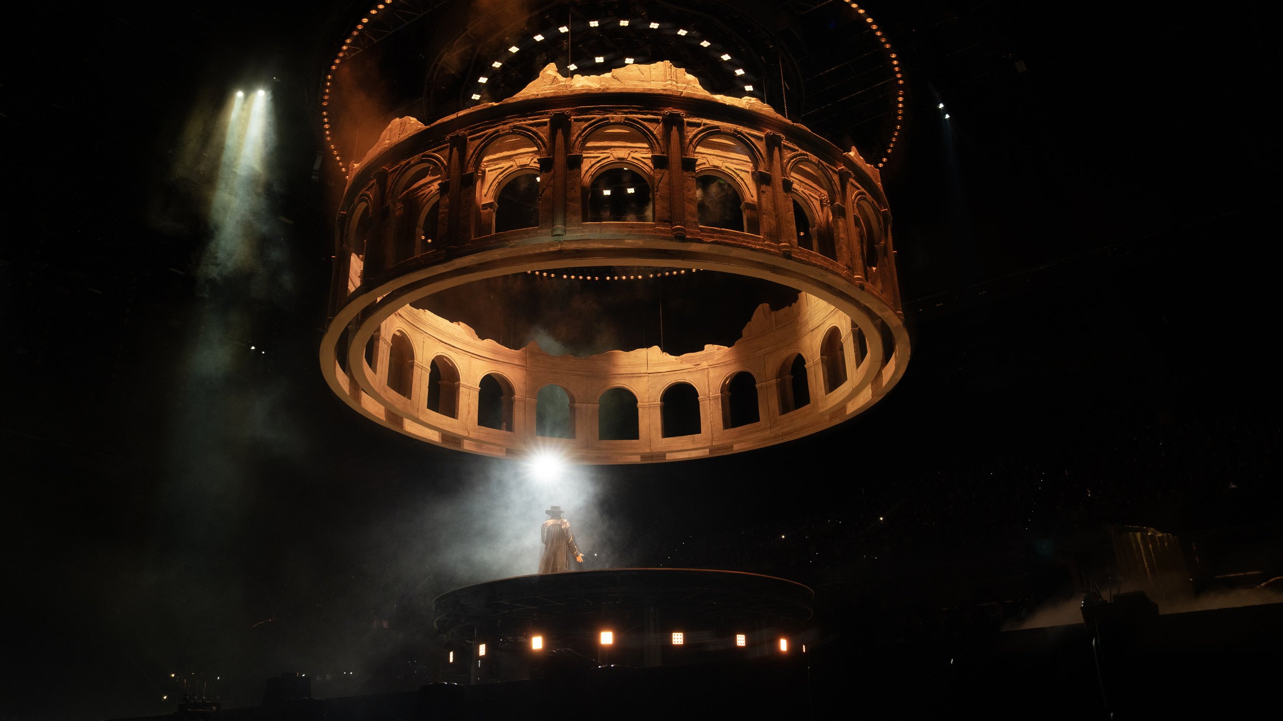 Monumental ruined colosseum suspended above KUN 蔡徐坤 for DEADMAN, concert stage and set design by Ruby Law