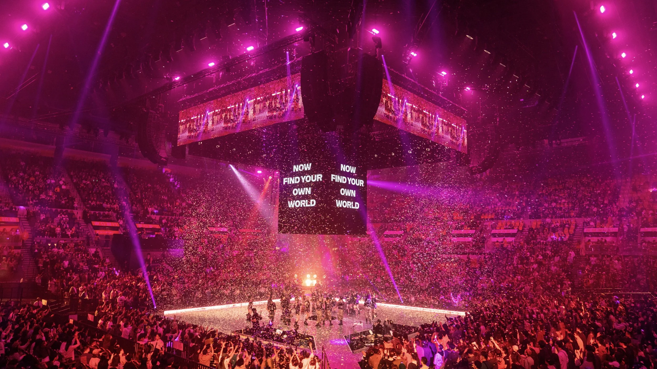 Finale of Jace World concert with confetti, dancers and central LED cube displaying Now Find Your Own World, arena stage design by London set designer Ruby Law.