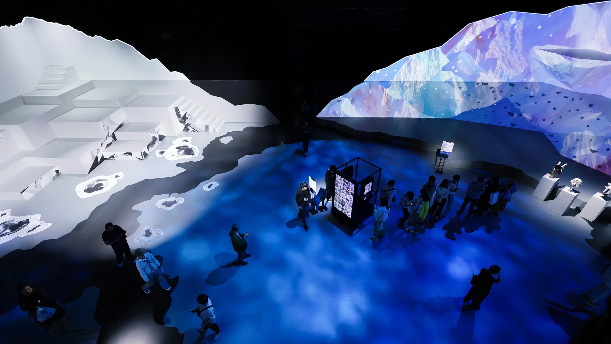 Immersive exhibition environment with audience and large-scale projection landscapes, design by Ruby Law RULA London set designer