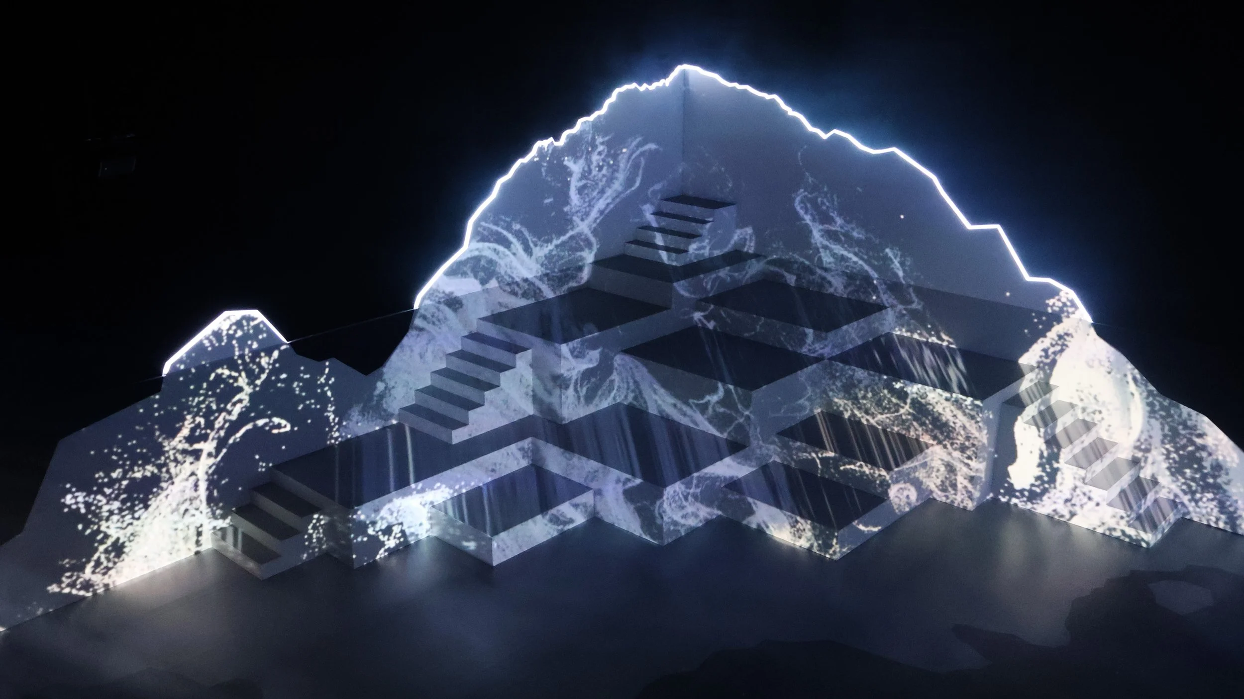 Abstract projection visuals across mountain stage, immersive set design by Ruby Law RULA London