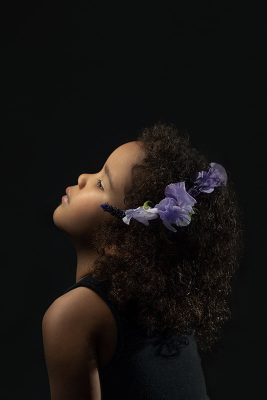curly-haired-girl-purple-flowers.jpg