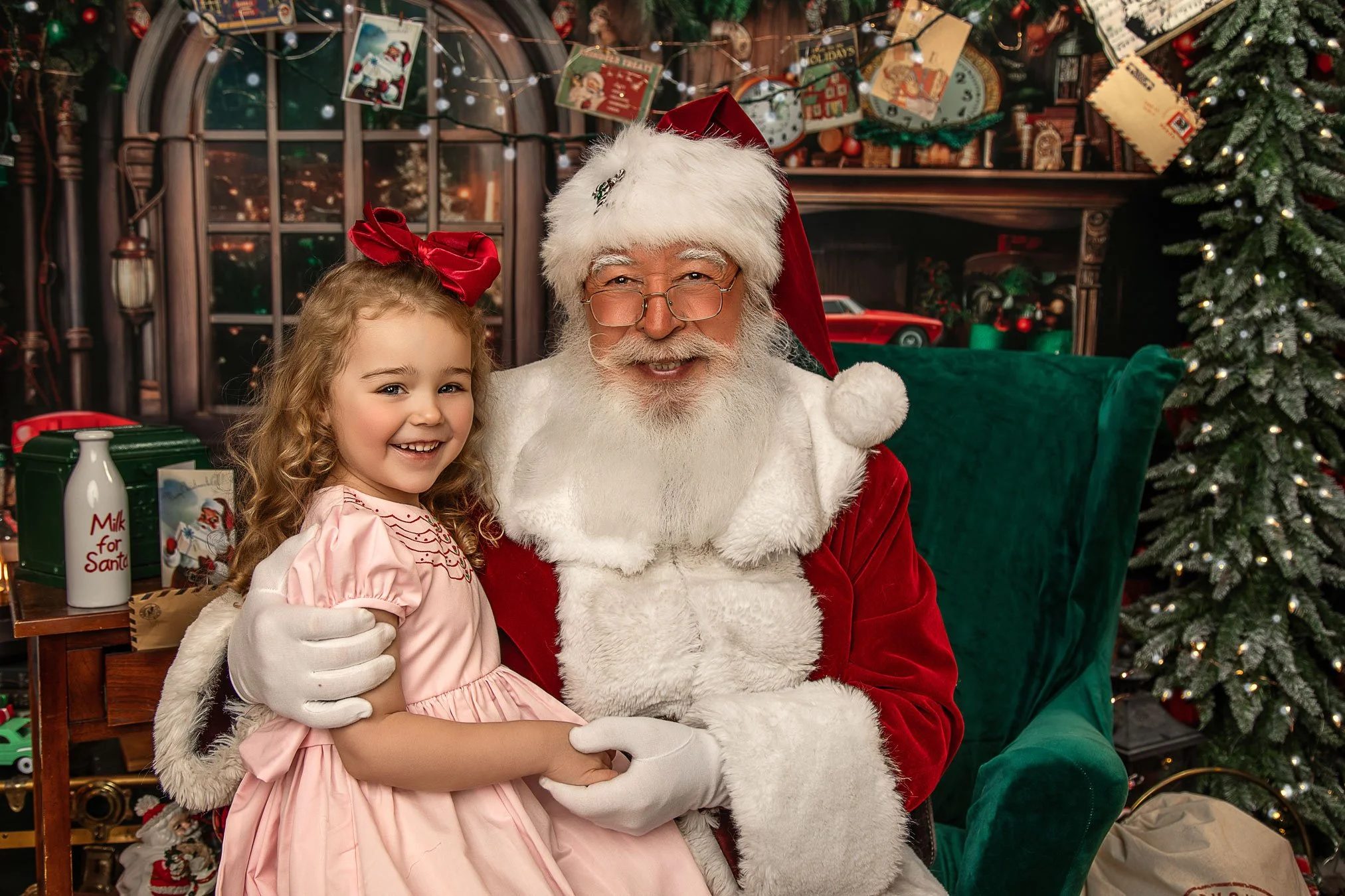 Little girl sitting on Santa's lap