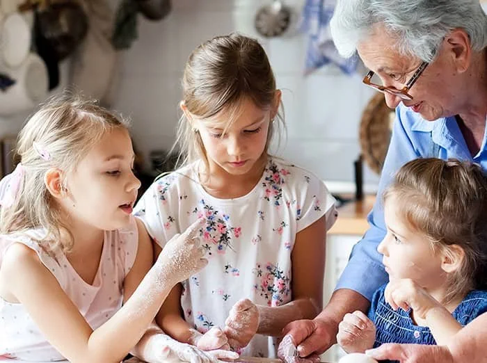 kids baking for holidays with grandparent