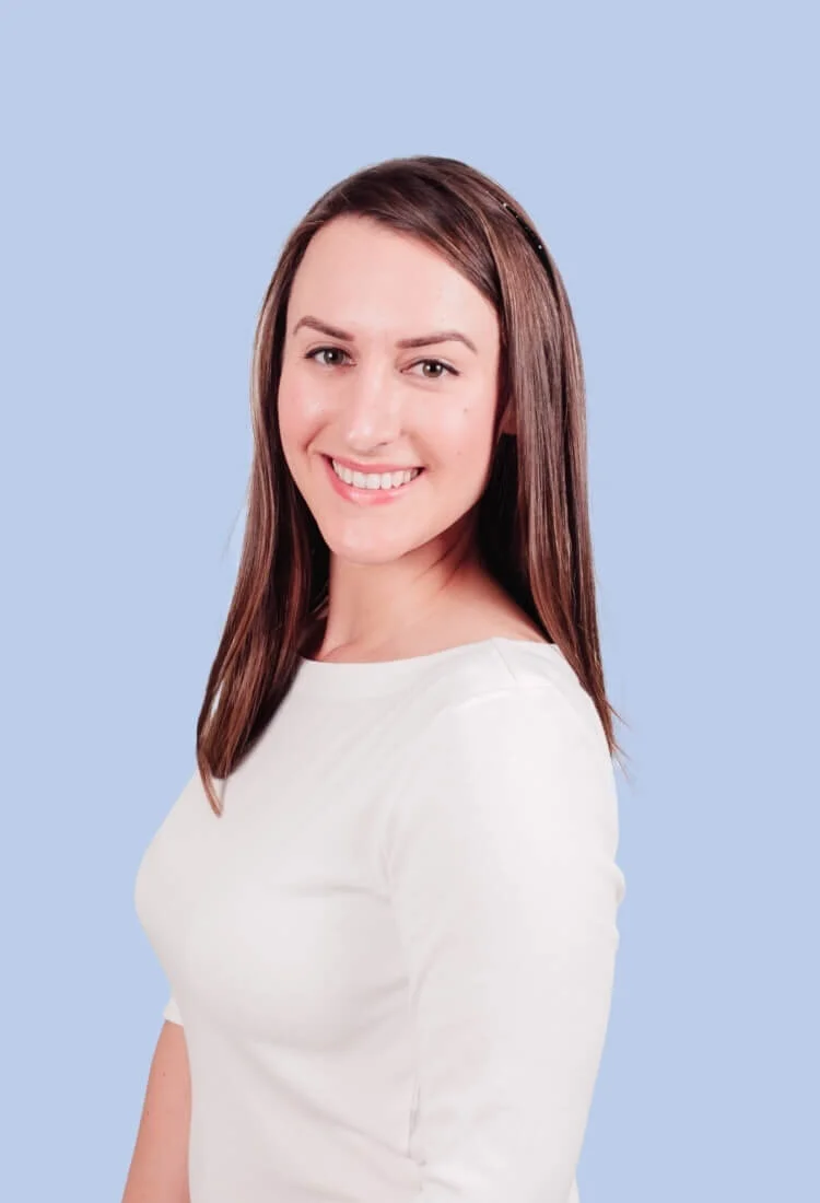 Headshot of Rae Targos from Productive Co. wearing white on a blue background