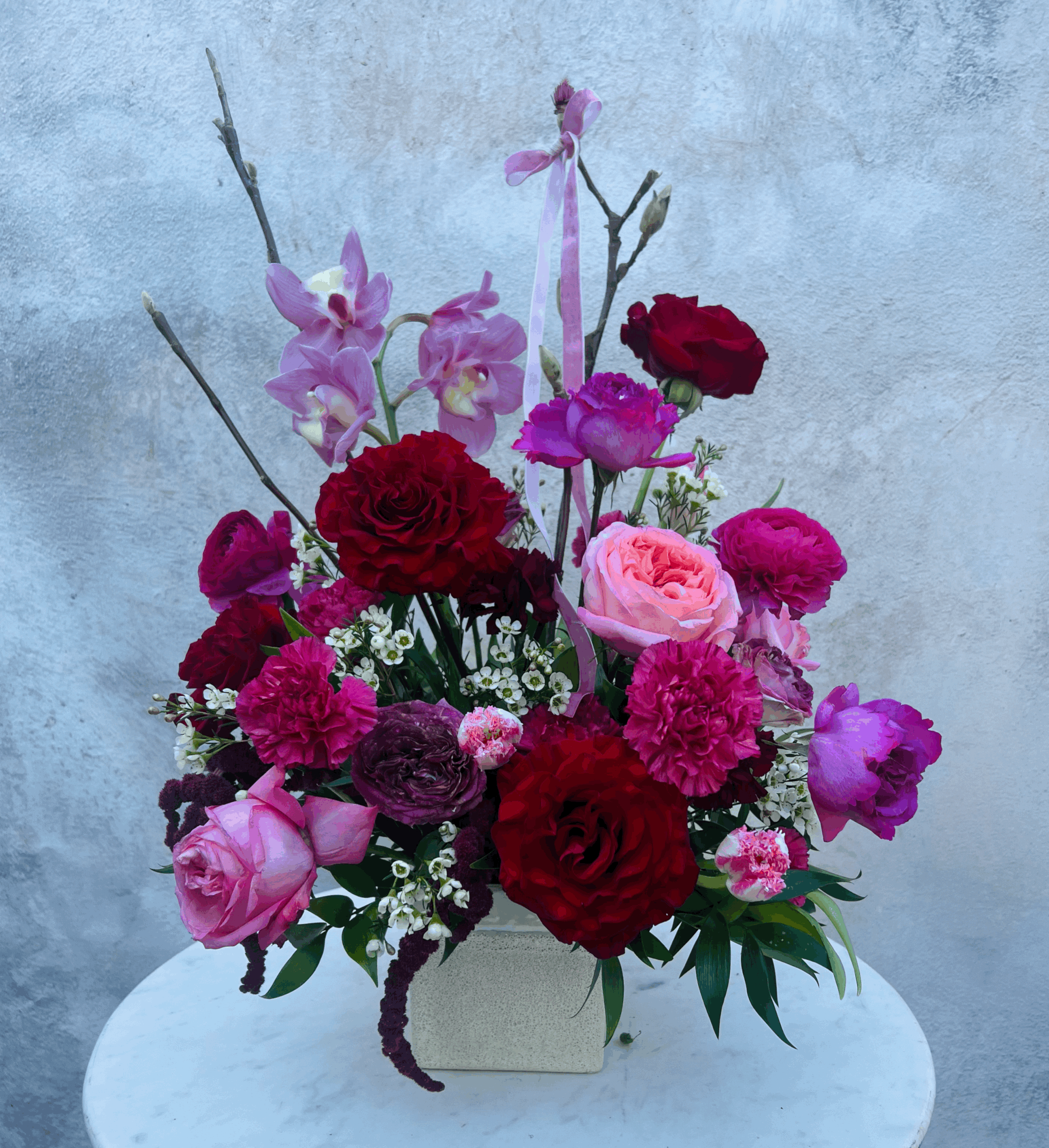 Luxury Valentine’s Day flower arrangement in shades of red and pink designed by The Nature of Things Fine Flowers in Riverside CA.