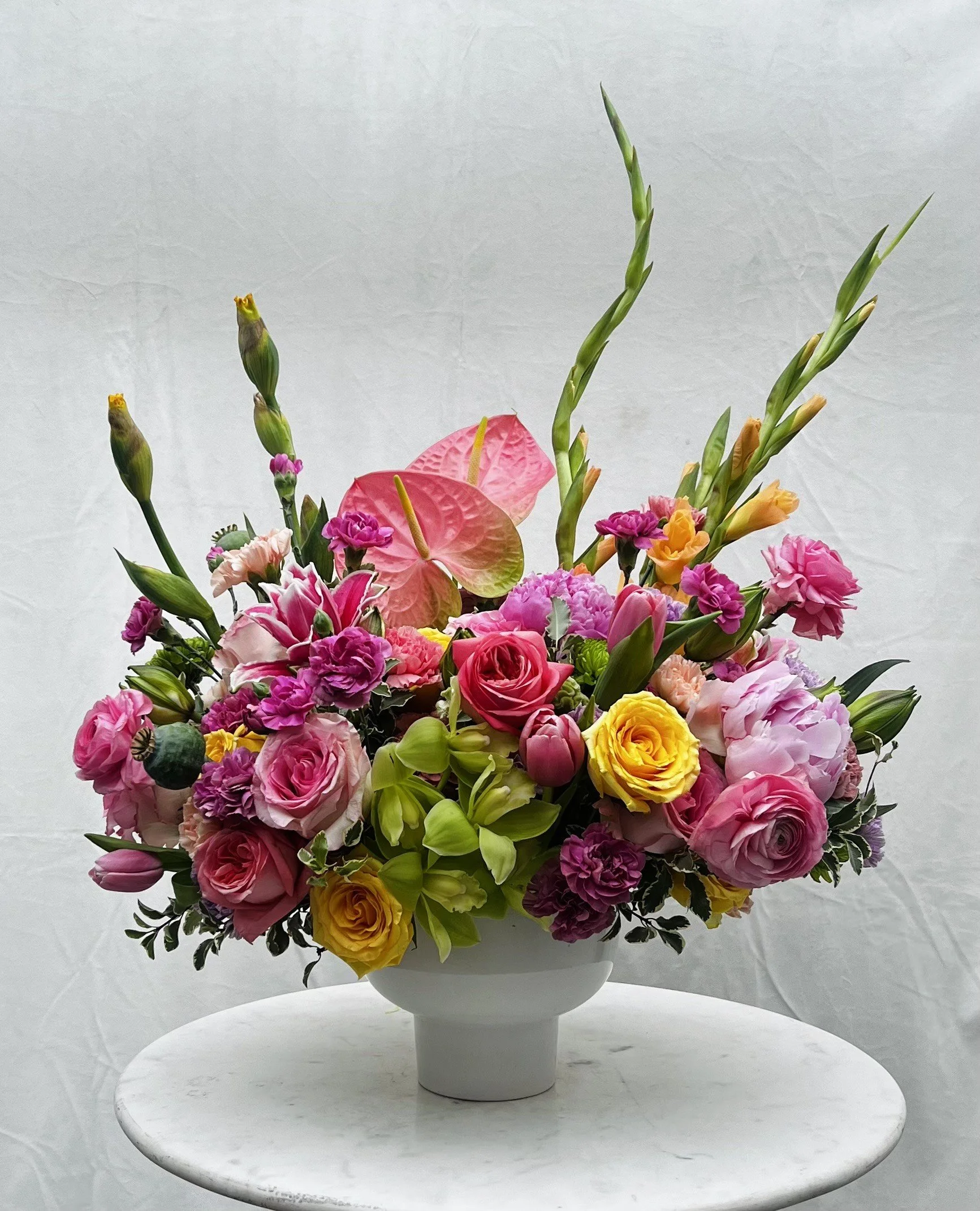 Luxury spring floral arrangement with premium blooms including anthurium orchids and peonies