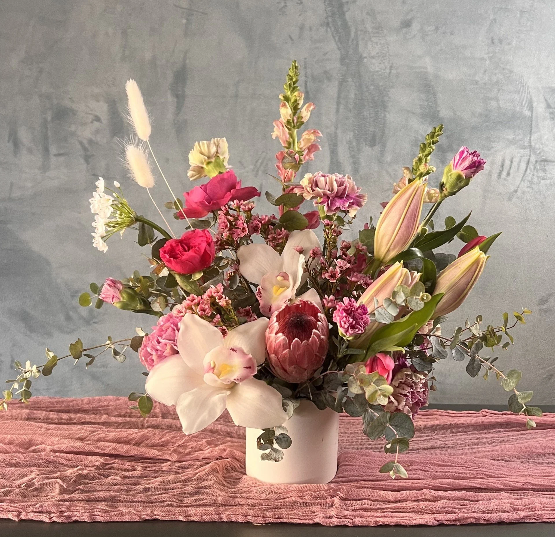 structured-pink-white-floral-arrangement-protea-orchid-riverside-nora.jpg