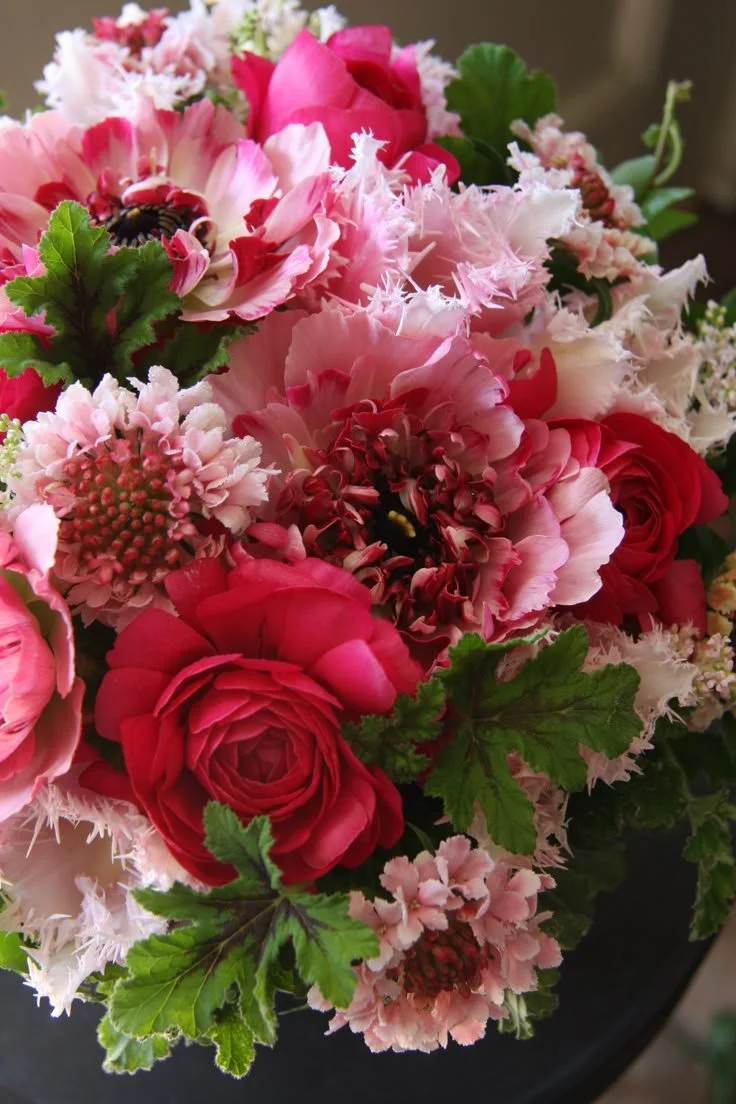 Close-up of soft pink seasonal flowers with delicate petals and natural texture in a garden-style floral arrangement