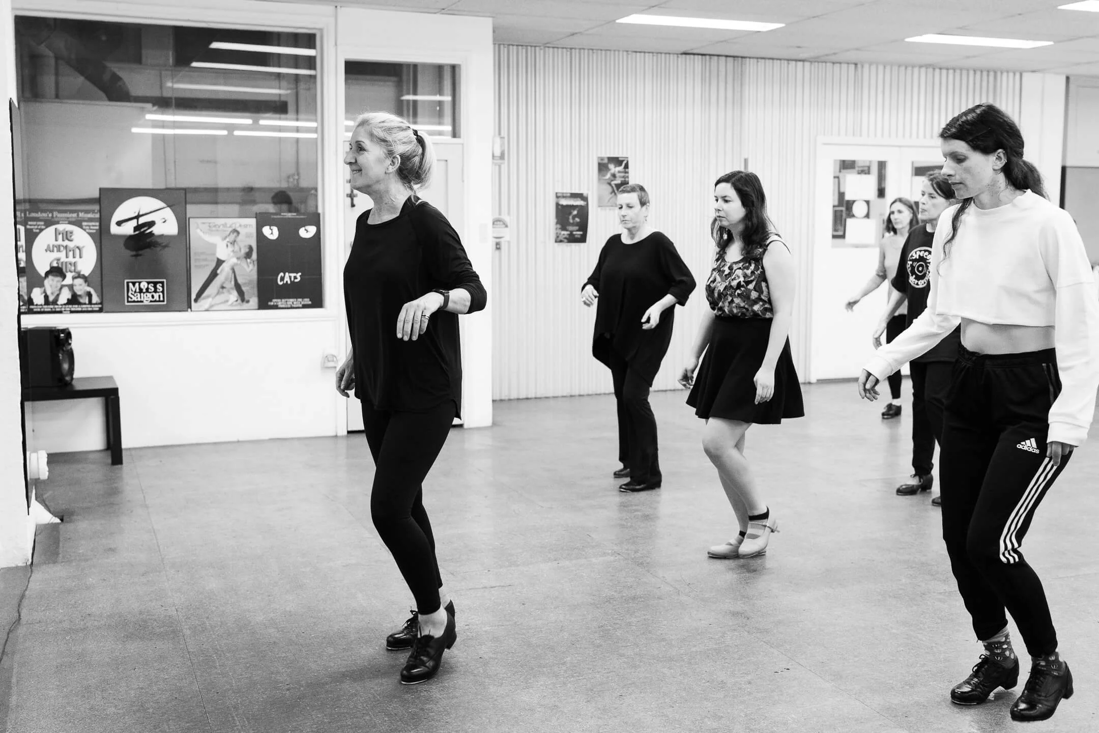 B&W image of a group of adult women learning tap dance at a Melbourne Dance studio
