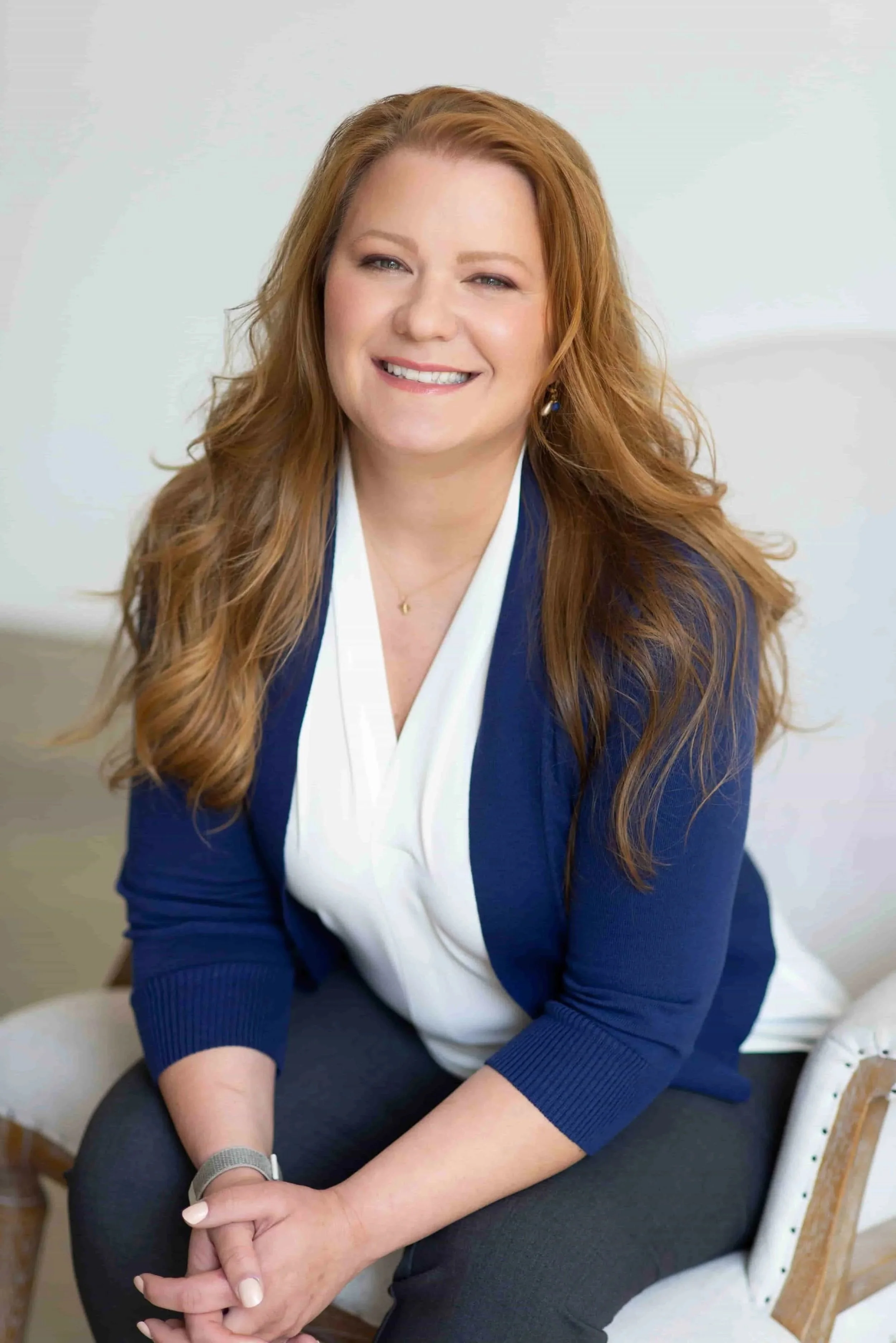 Anna Khandrueva, an accelerated resolution therapist, smiling at the camera while wearing a blue blazer over a white top.