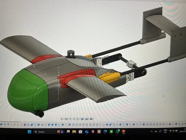 Digital rendering of a small drone with a streamlined body, green nose cone, and large wings, featuring a large propeller or turbine at the rear and various mechanical components visible underneath.