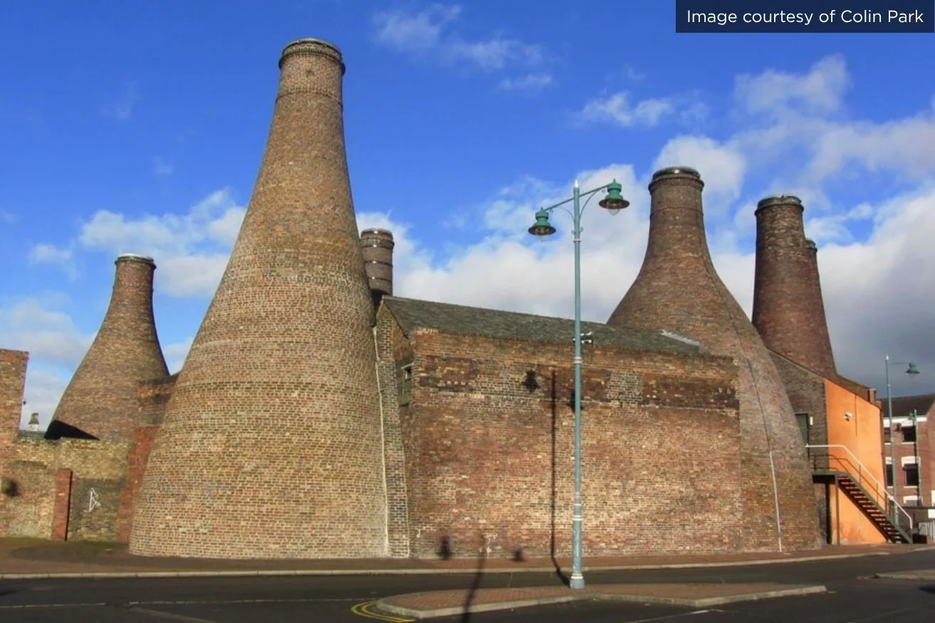 Red brick bottle kilns against a blue sky at Gladstone Pottery Museum