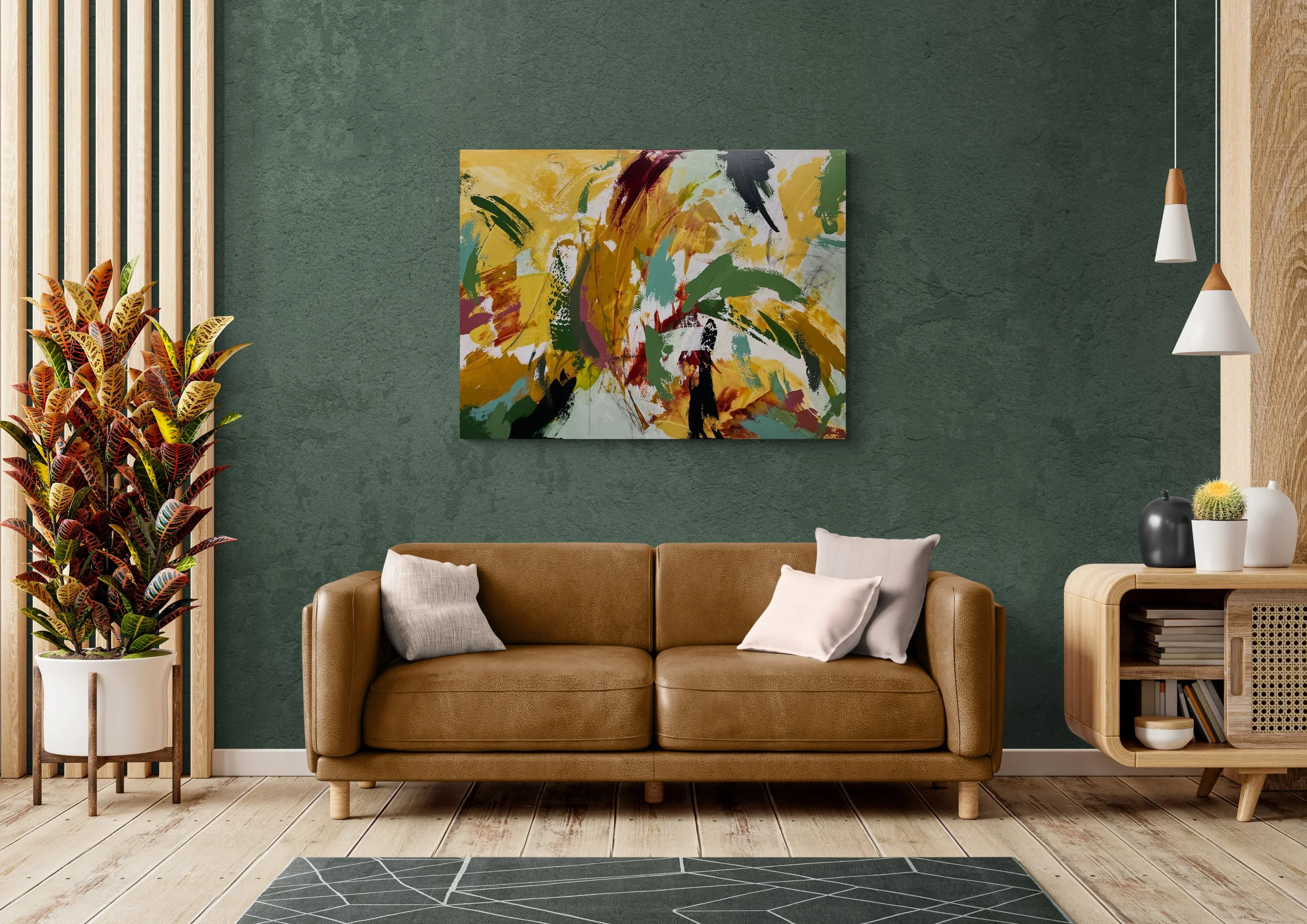 Modern living room with a green textured wall, a tan leather sofa with white and gray pillows, colorful abstract art on the wall, a tall potted plant, and a wooden sideboard with decorative vases, with two hanging pendant lights.
