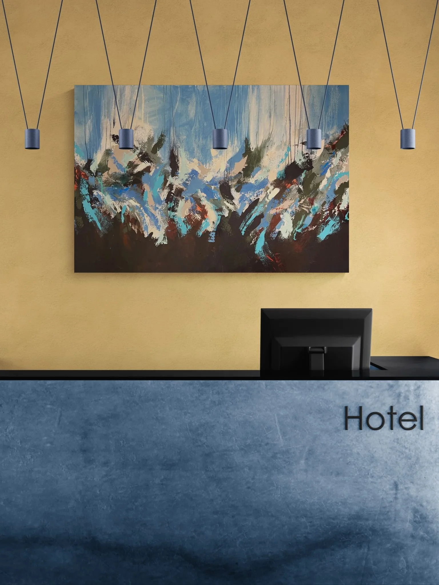 Hotel reception desk with a computer, yellow wall with colorful abstract painting and hanging blue pendant lights.