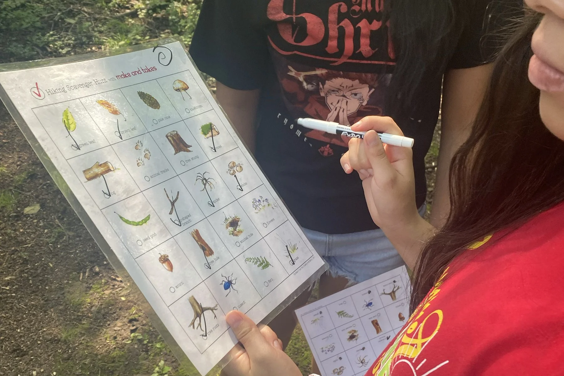 Girl holding a scavenger hunt check list