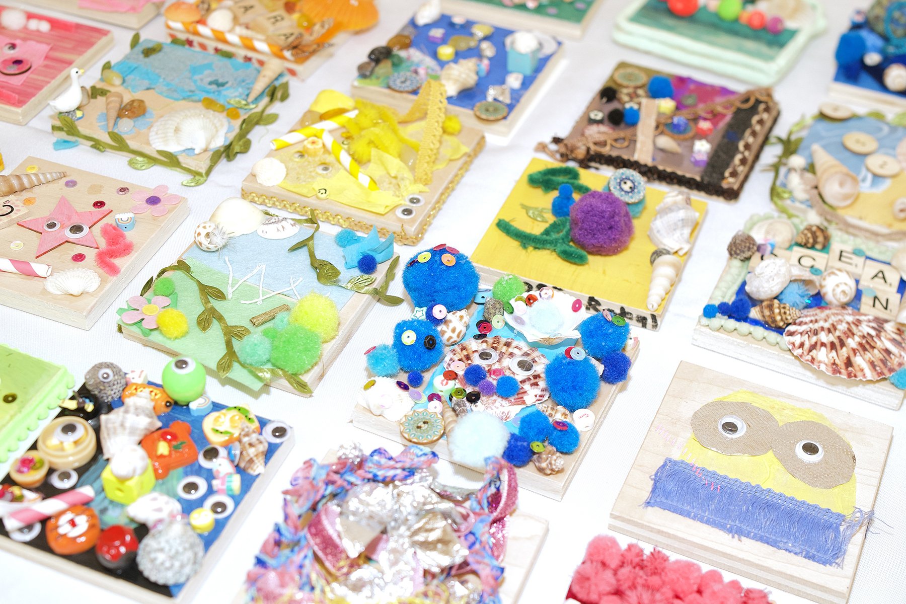 A group of handmade tiles with googly eyes