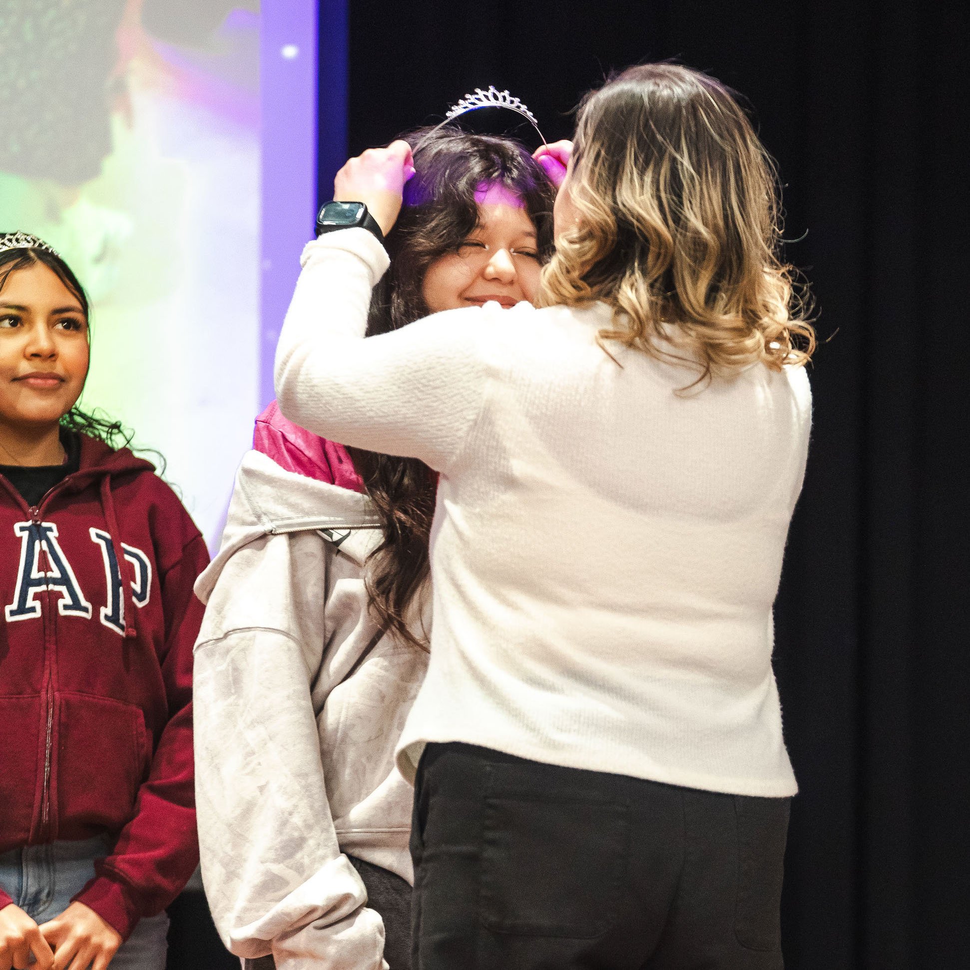 Latina girl receiving her Quinceñera tiara