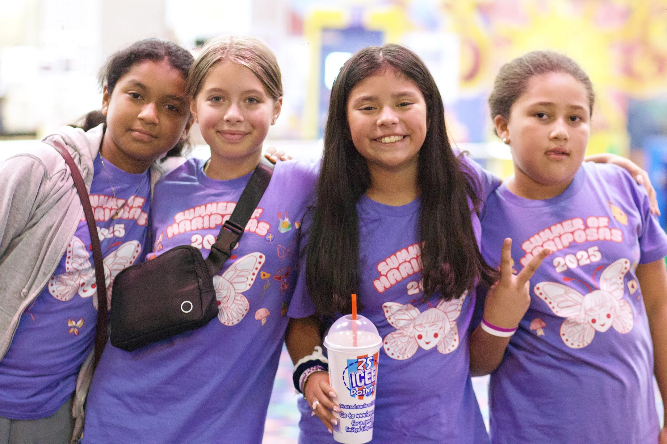 Group of four young Latina Girls smiling with arms around each other