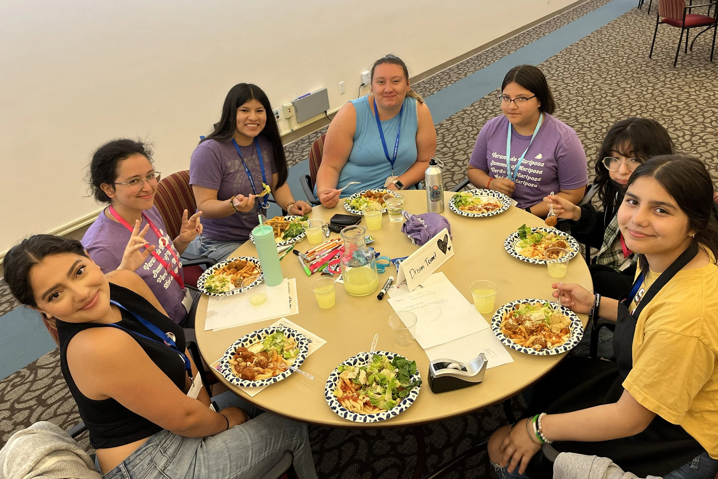 Group of Latina girls and women at a table having lunch