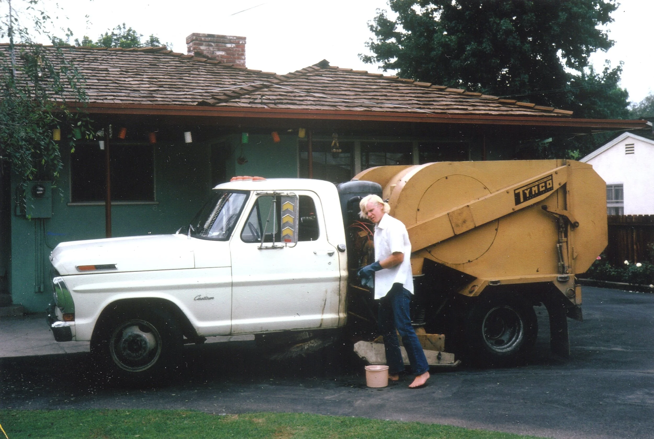 Business owner Paul Murphy cleaning his Tymco truck in 1971, when it all began