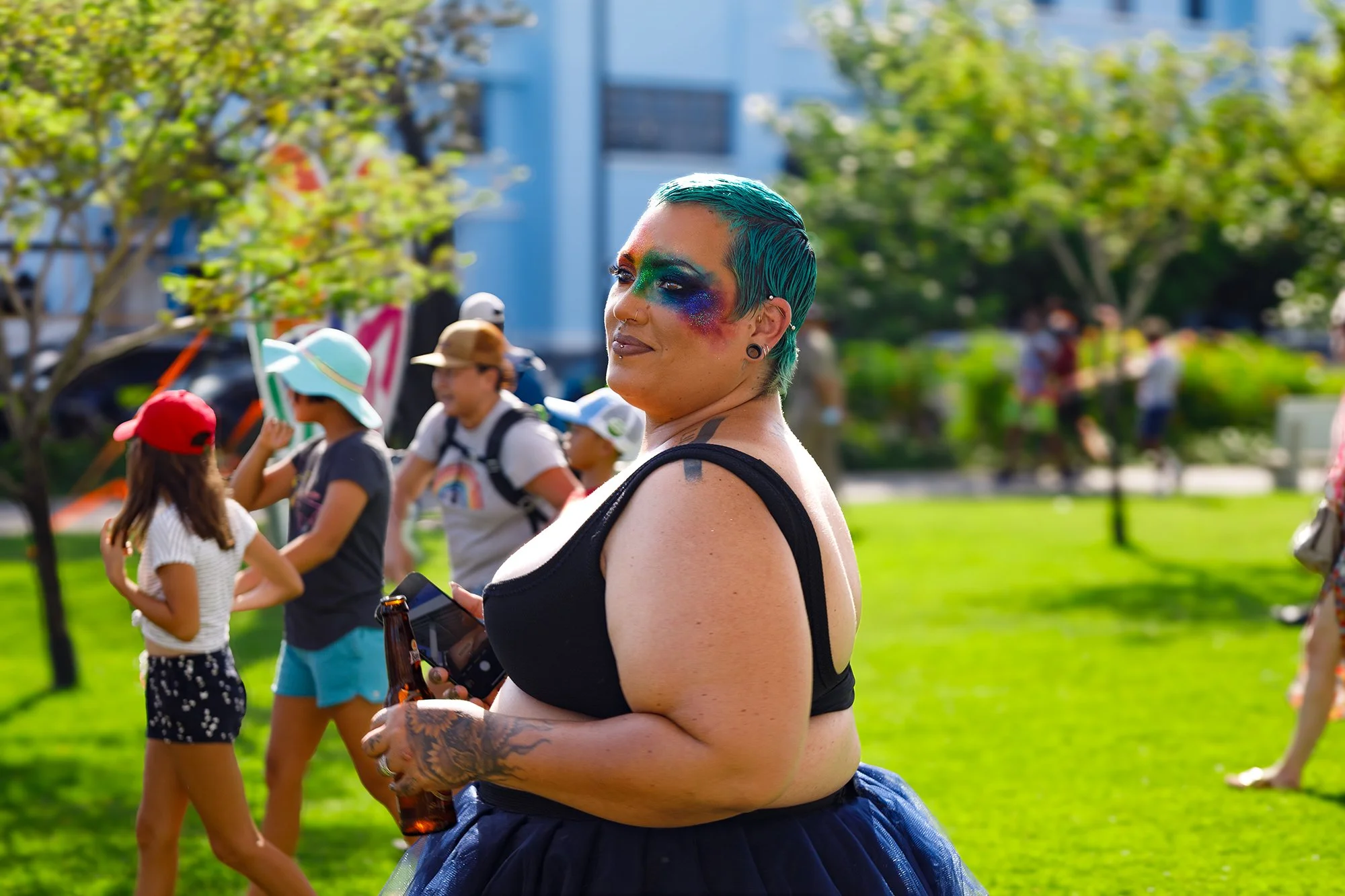 Portrait of a Barbados Pride participant with turquoise hair and colorful face paint during the parade in Bridgetown, photographed by Alyson Holder.