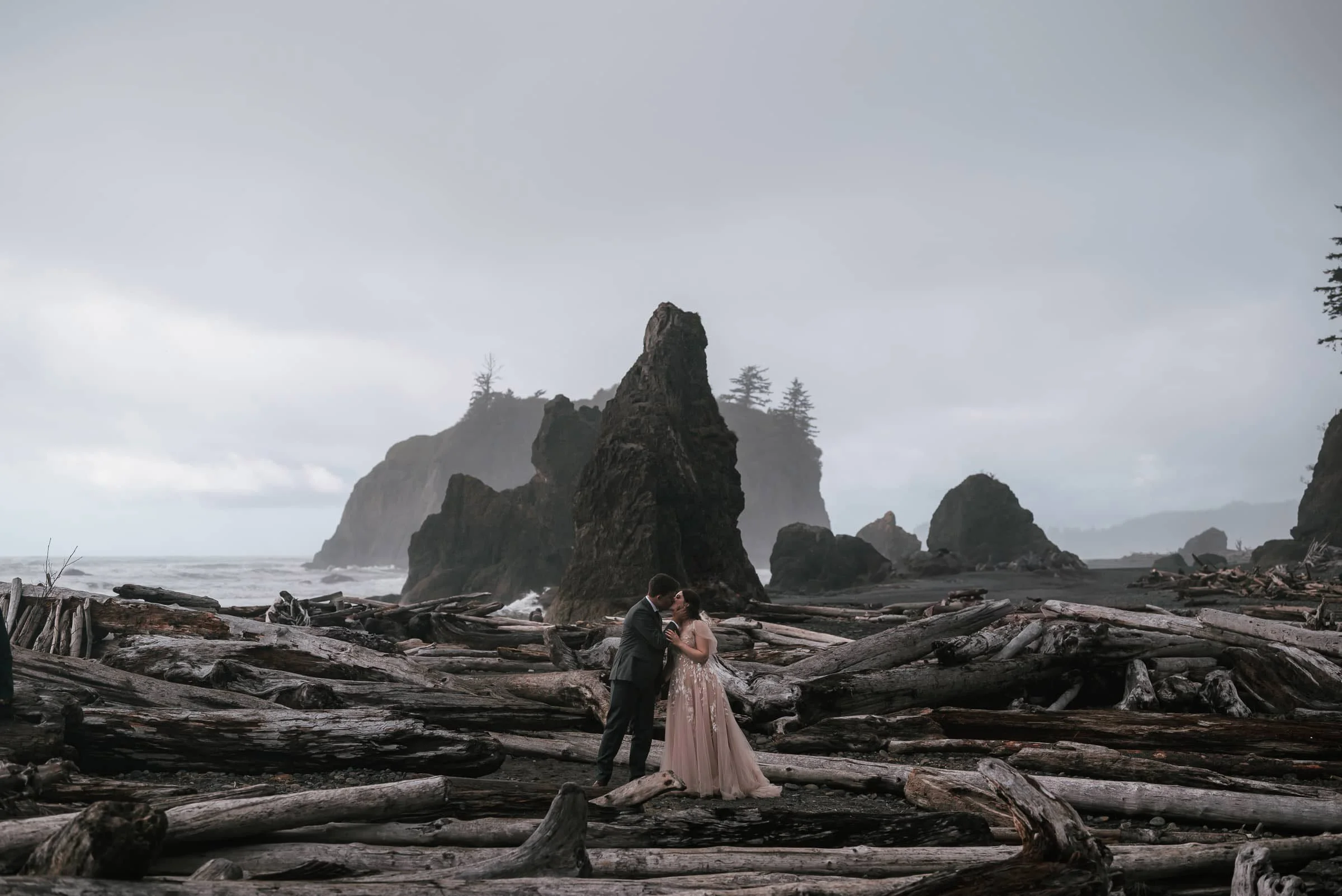 romantic kiss between couple at their ruby beach wedding
