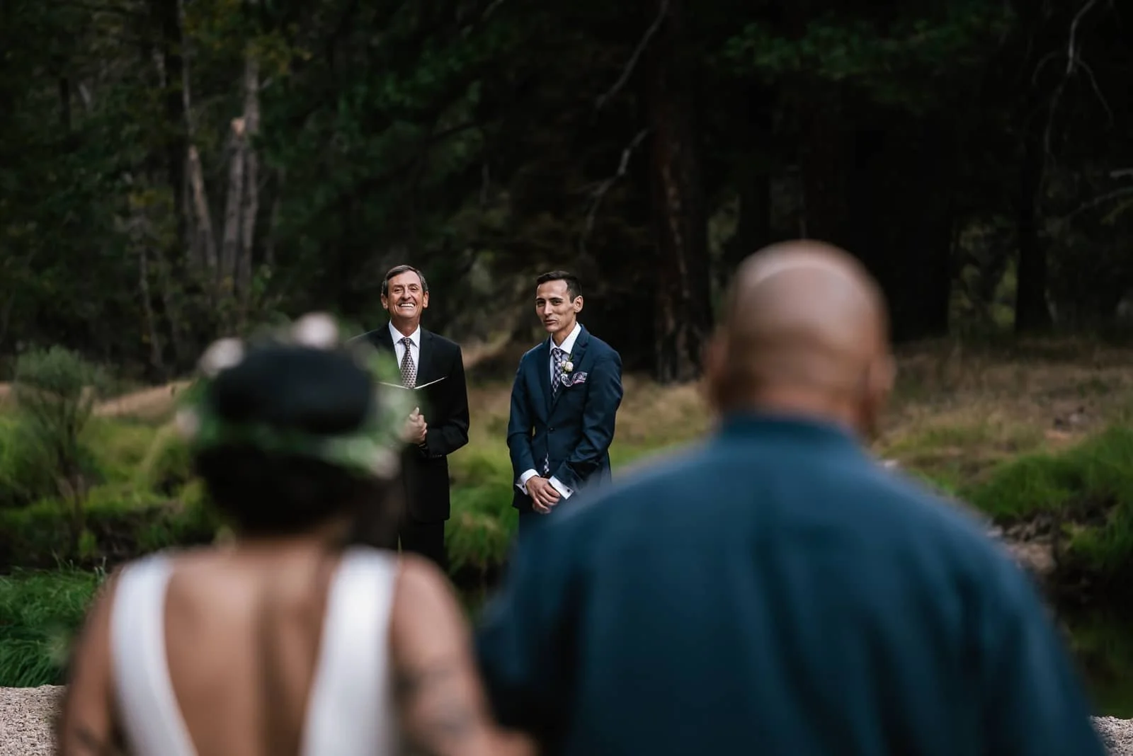 groom smiles at seeing his bride for the first time.