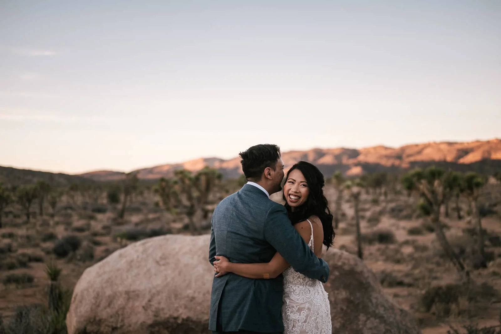 bride looks back to her adventure elopement photographer with a big smile