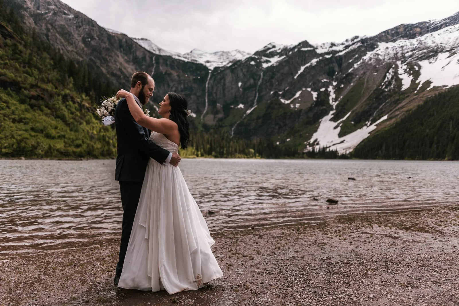 First dance with a flower bouquet beside the lake.