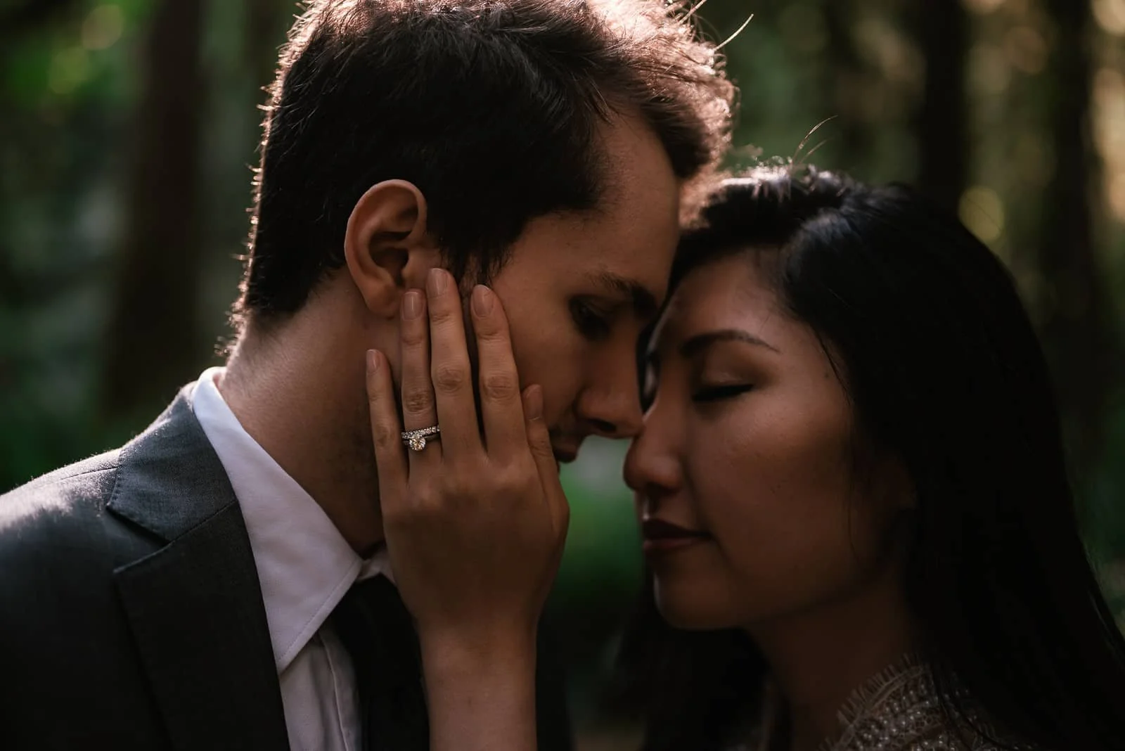 engagement ring on display during tender moment between newlyweds
