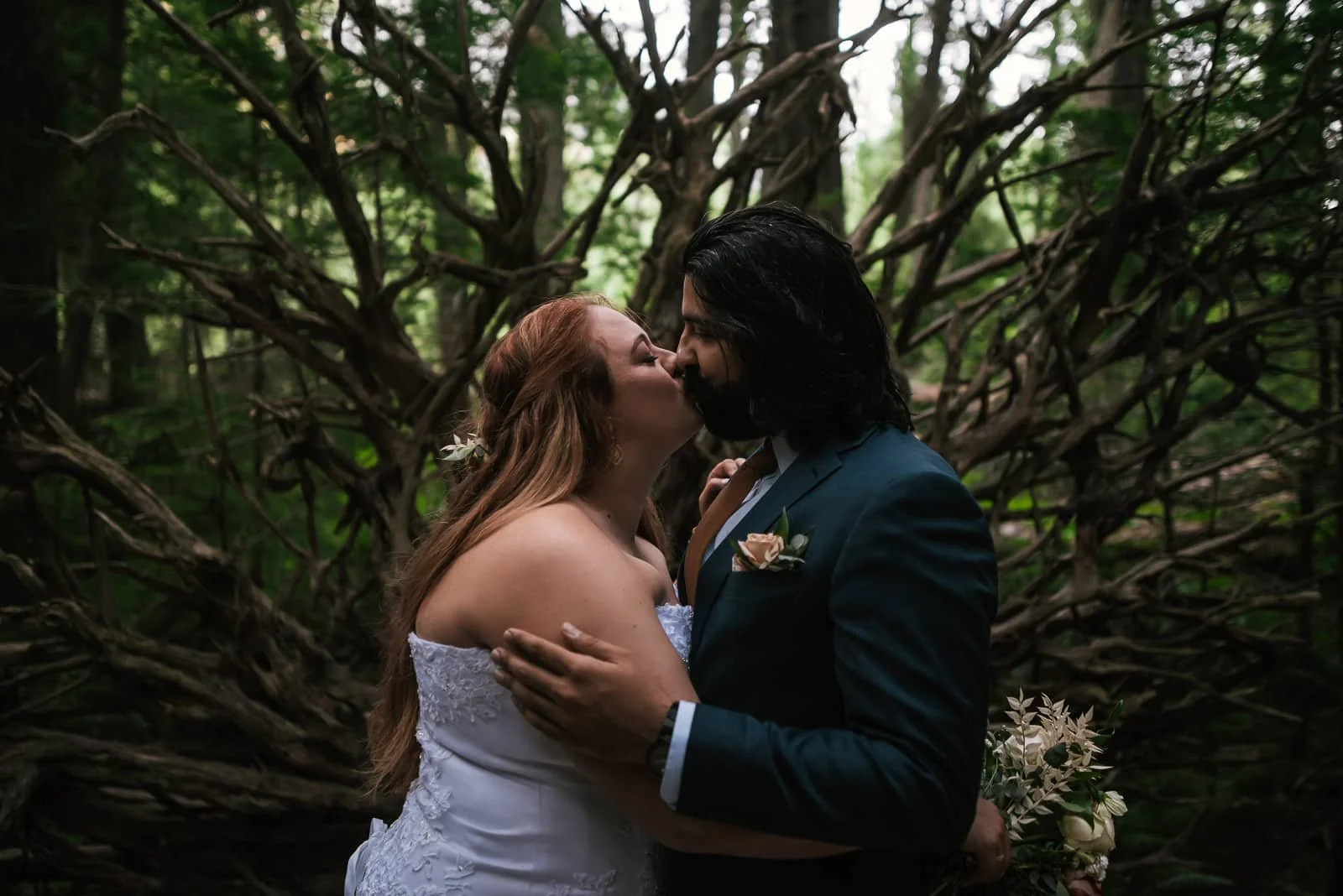 Newlyweds kiss near the Fish Creek Amphitheater