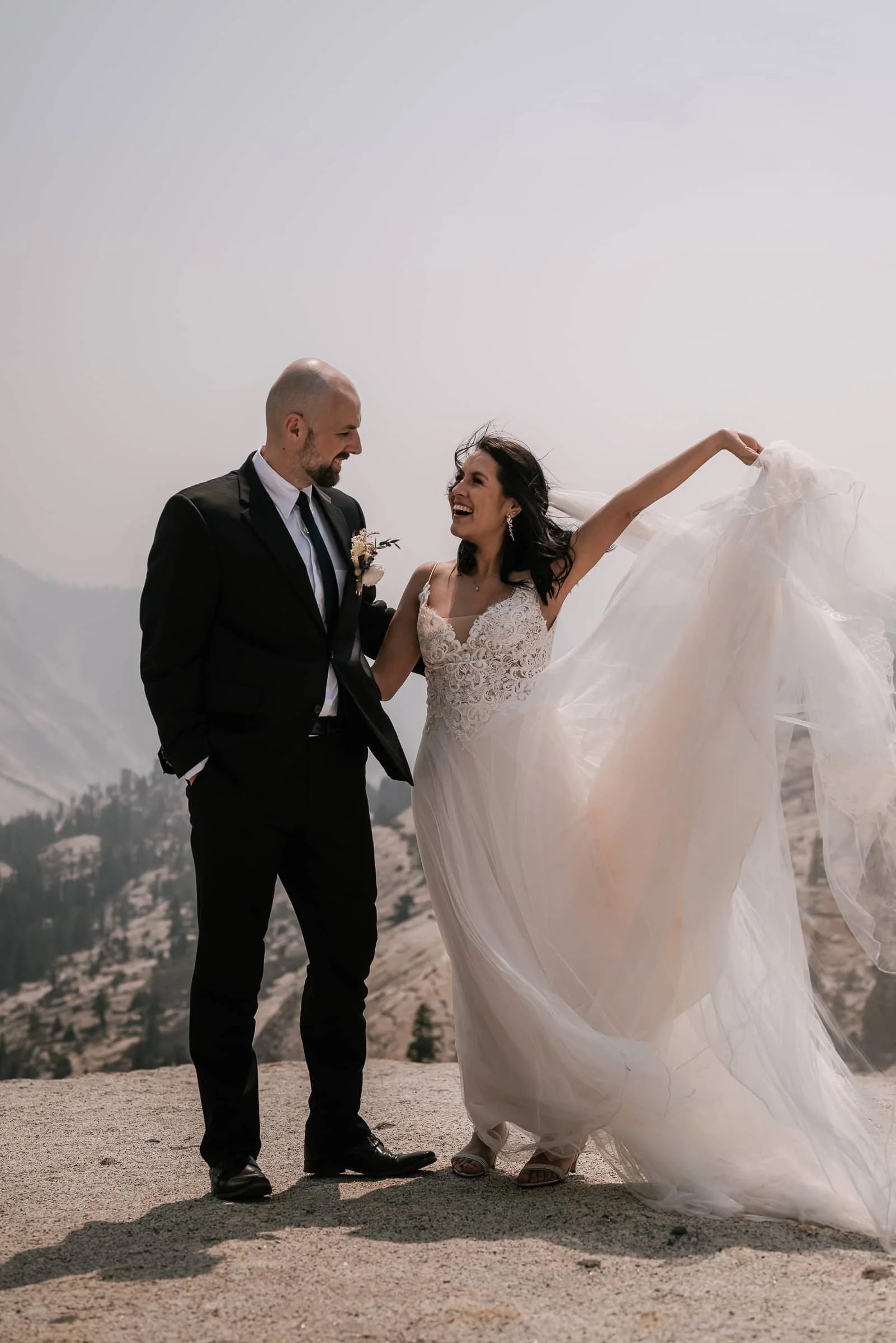 bride raises arm in celebration at olmsted point wedding
