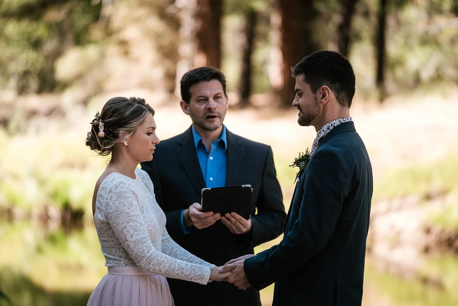 Couple holds back tears as they say I do at Cathedral beach.