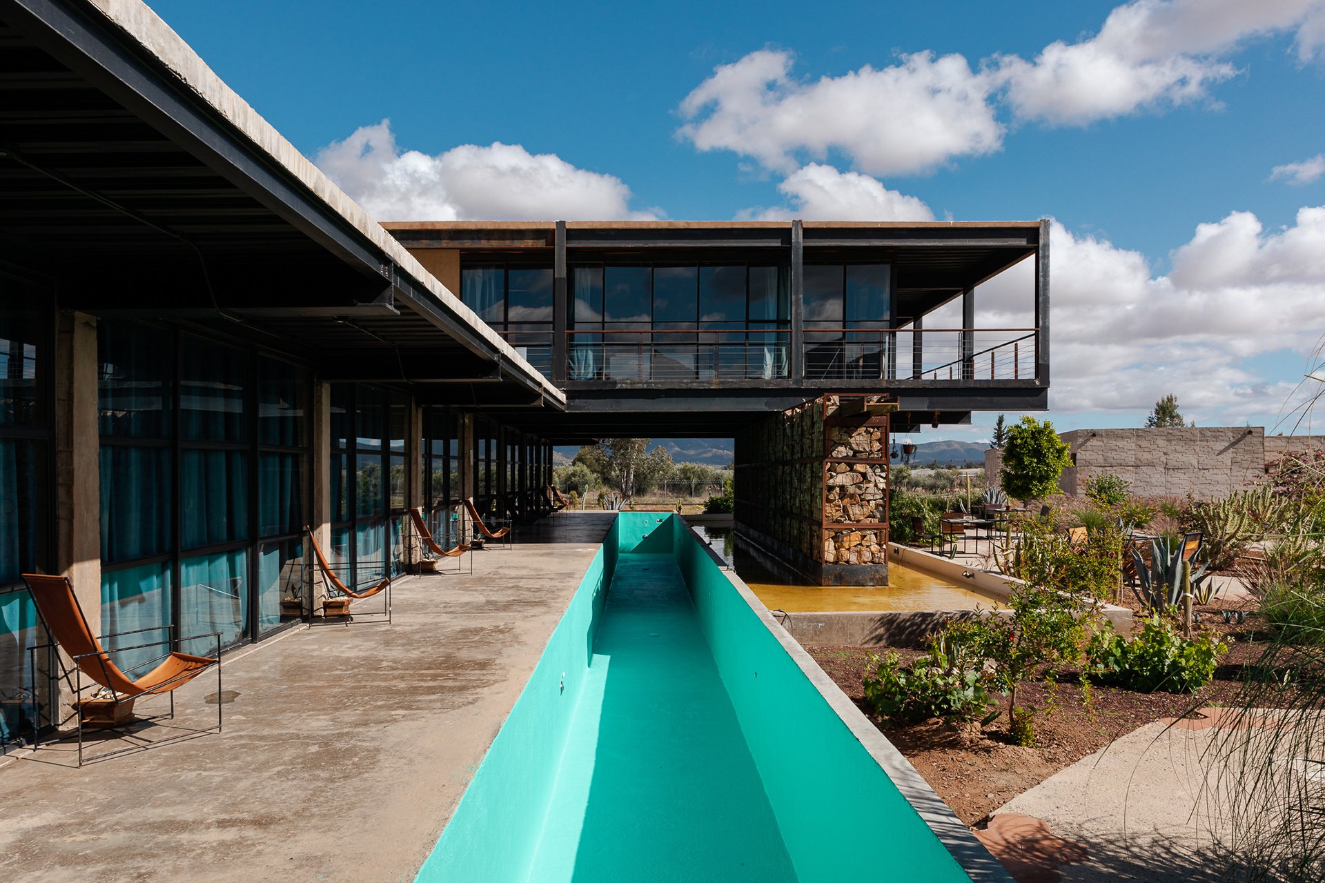 A turquoise pool complemented by sleek, modern architecture in a boutique hotel setting. My photography focuses on capturing clean, contemporary designs while emphasizing sustainability, ideal for brands in Melbourne and New Zealand. By Shava Cueva,