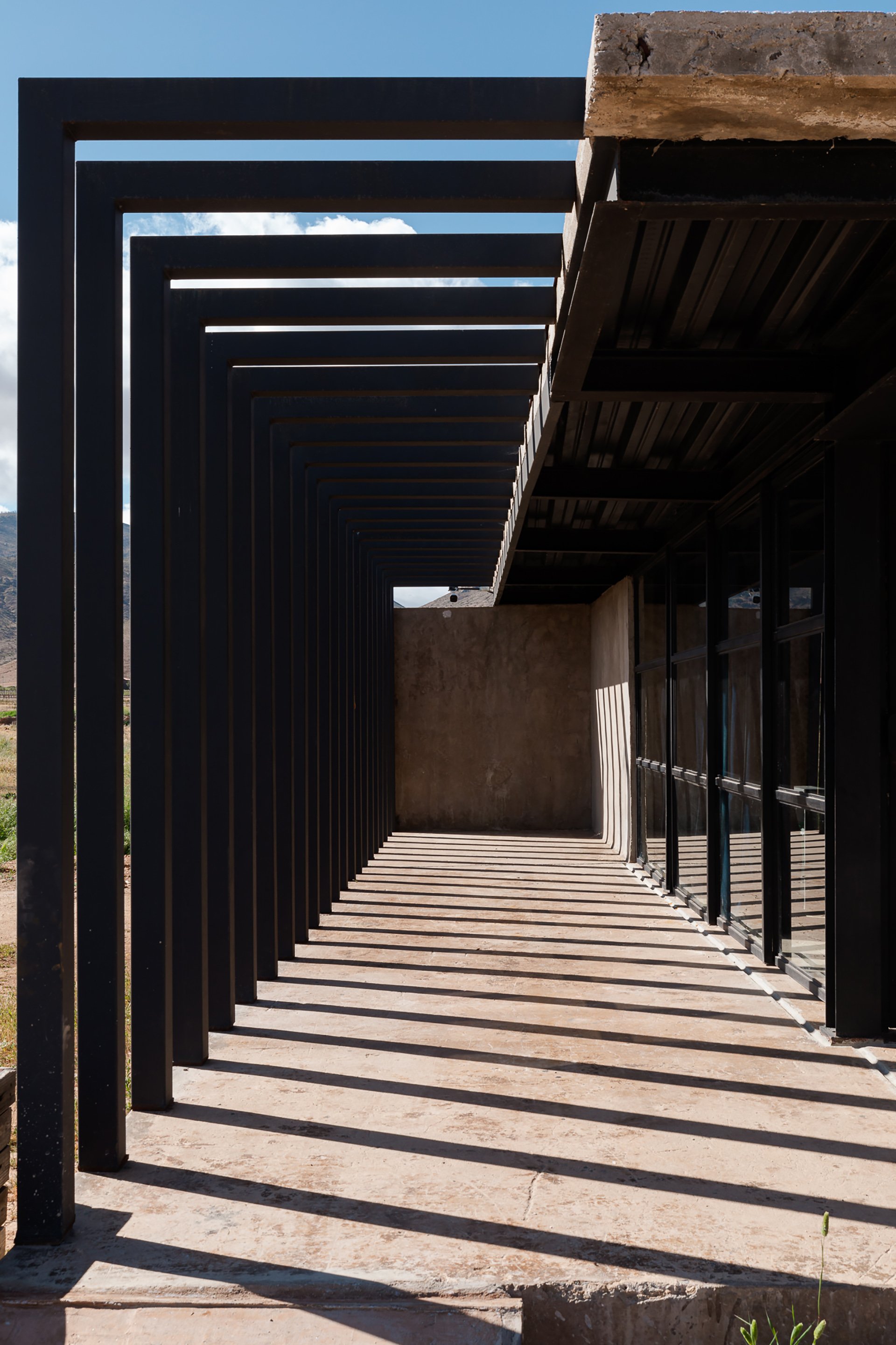 A bold, geometric steel-framed structure with striking shadows and clean lines. Ideal for architectural showcases or boutique properties in Mexico, Australia, Melbourne and New Zealand. I specialize in photographing architectural spaces to highlight