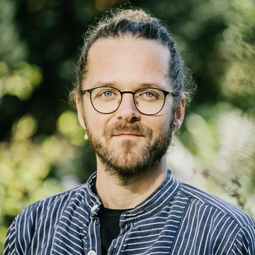 Der Autor Arne Sesmrott ist hier zu sehen, er blickt offen in die Kamera.