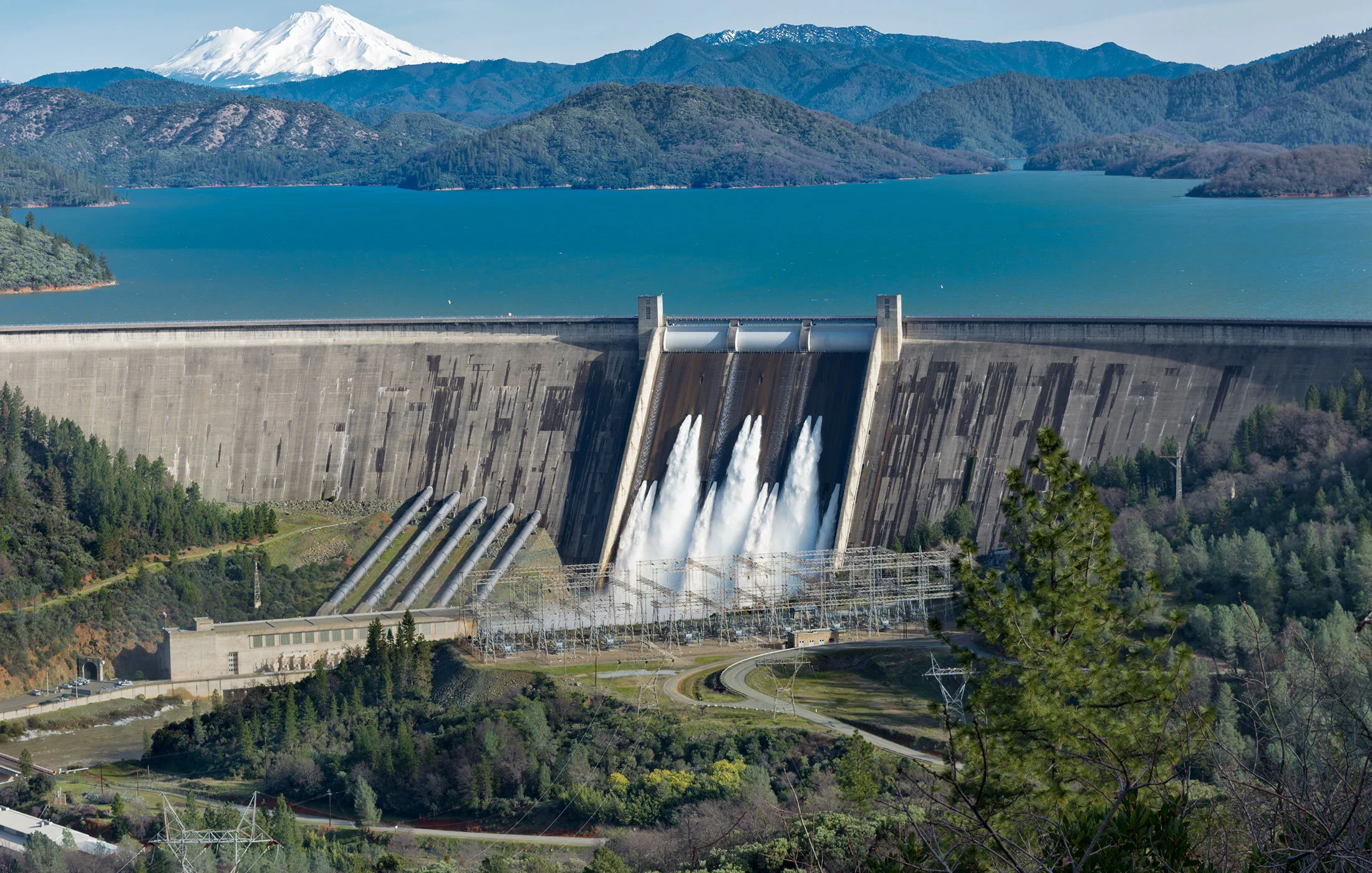picture-shasta-dam-surrounded-by-roads-trees-with-lake-mountains.jpg