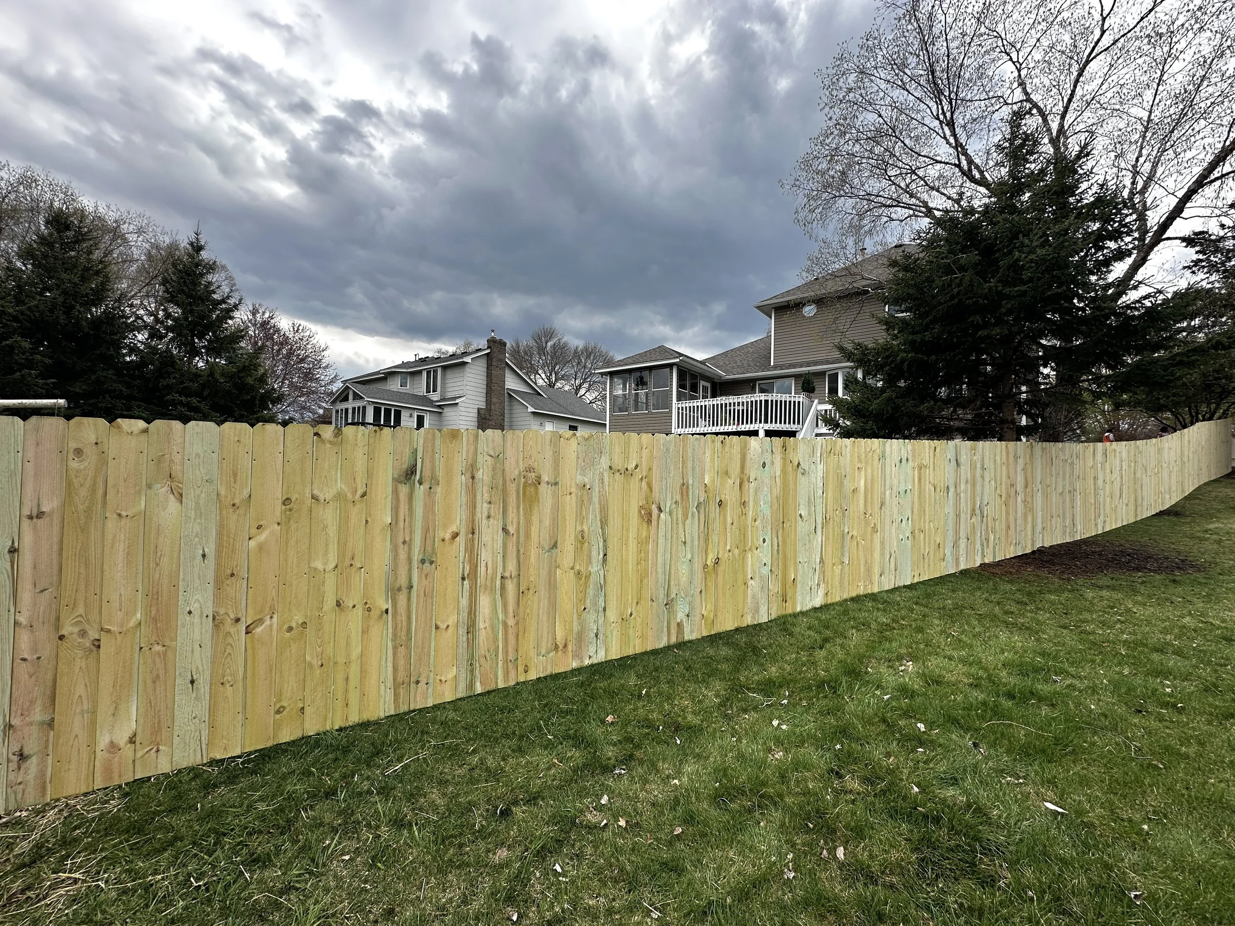 A Treated Pine Vertical Privacy Fence in Bloomington, MN. Built with Lifetime Warranty Steel Posts and Treated Pine. Assembled entirely with Screws.