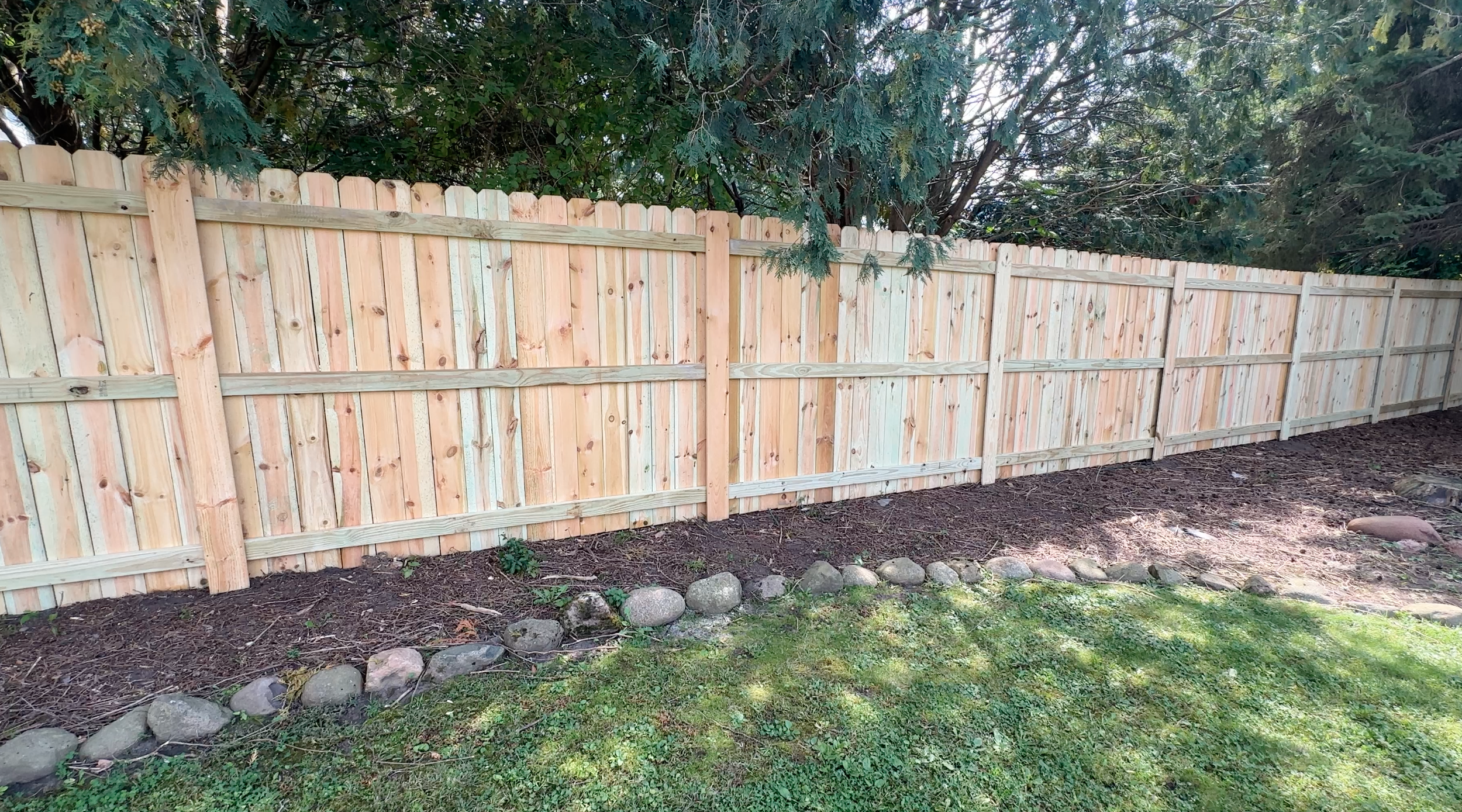 A Treated Pine Vertical Privacy Fence in Lino Lakes, MN. Built with Lifetime Warranty Steel Posts and Treated Pine. Assembled entirely with Screws.