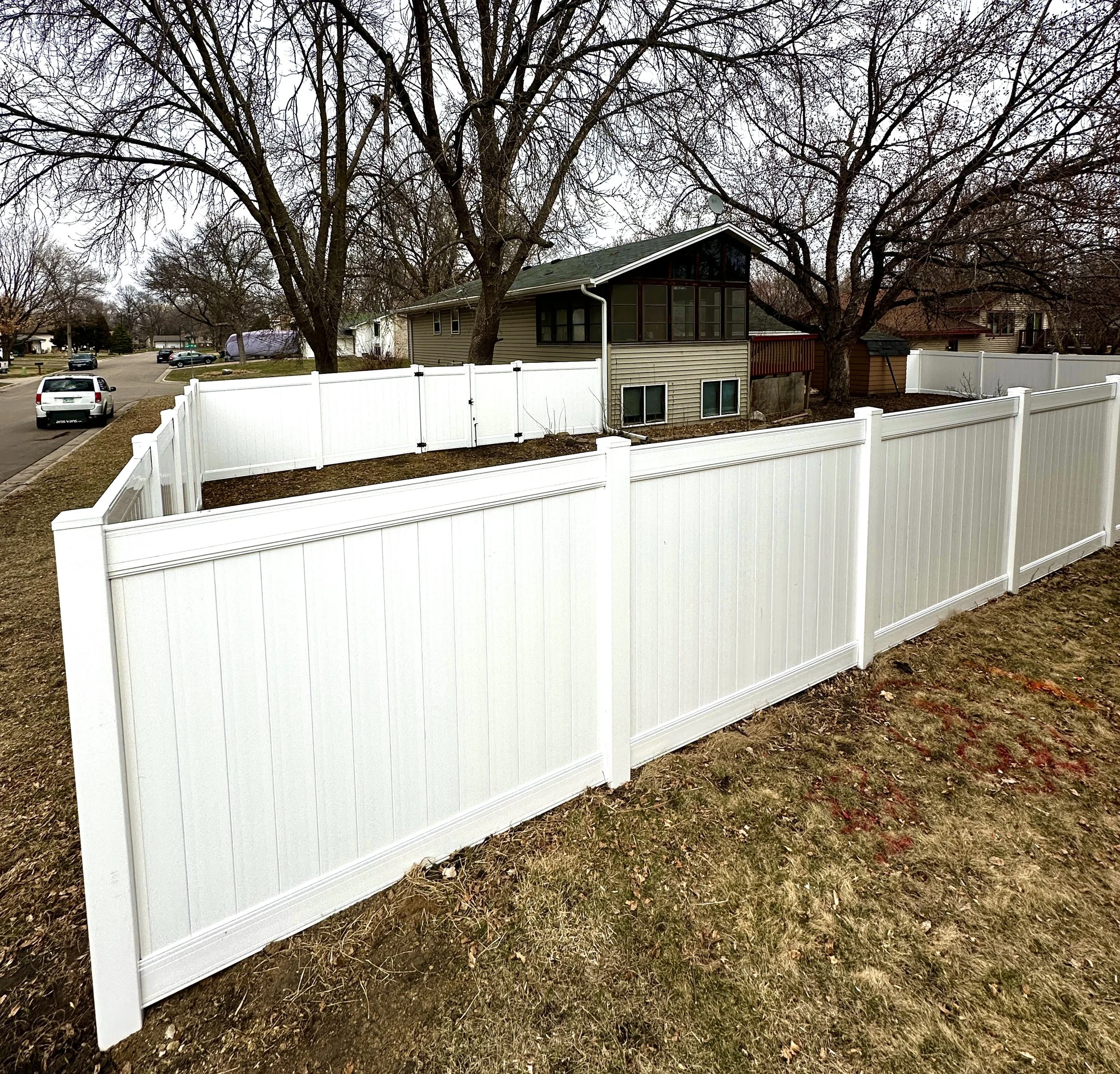 A White Vinyl Privacy Fence built in Brooklyn Park, MN. Built with Lifetime Warranty Steel Posts.