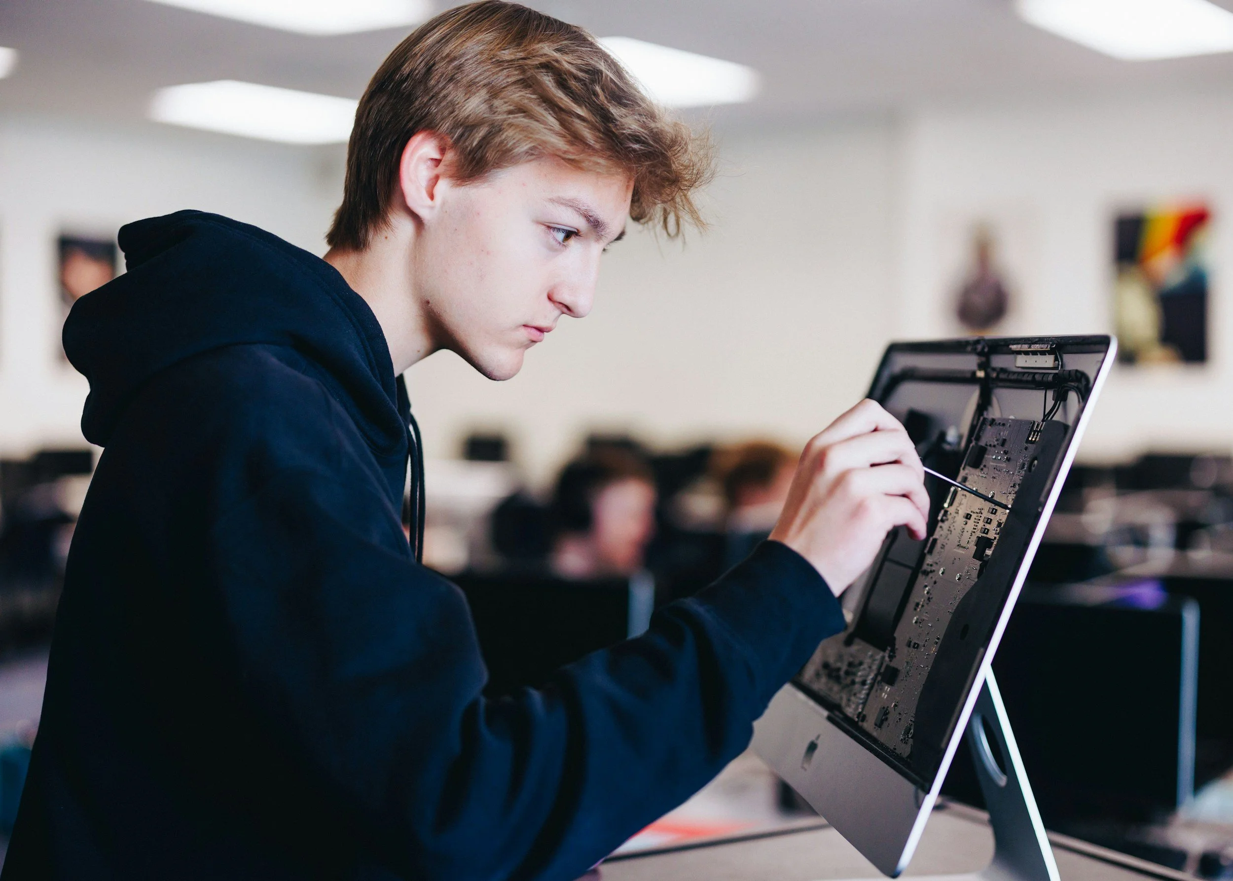 A student repairs a desktop screen